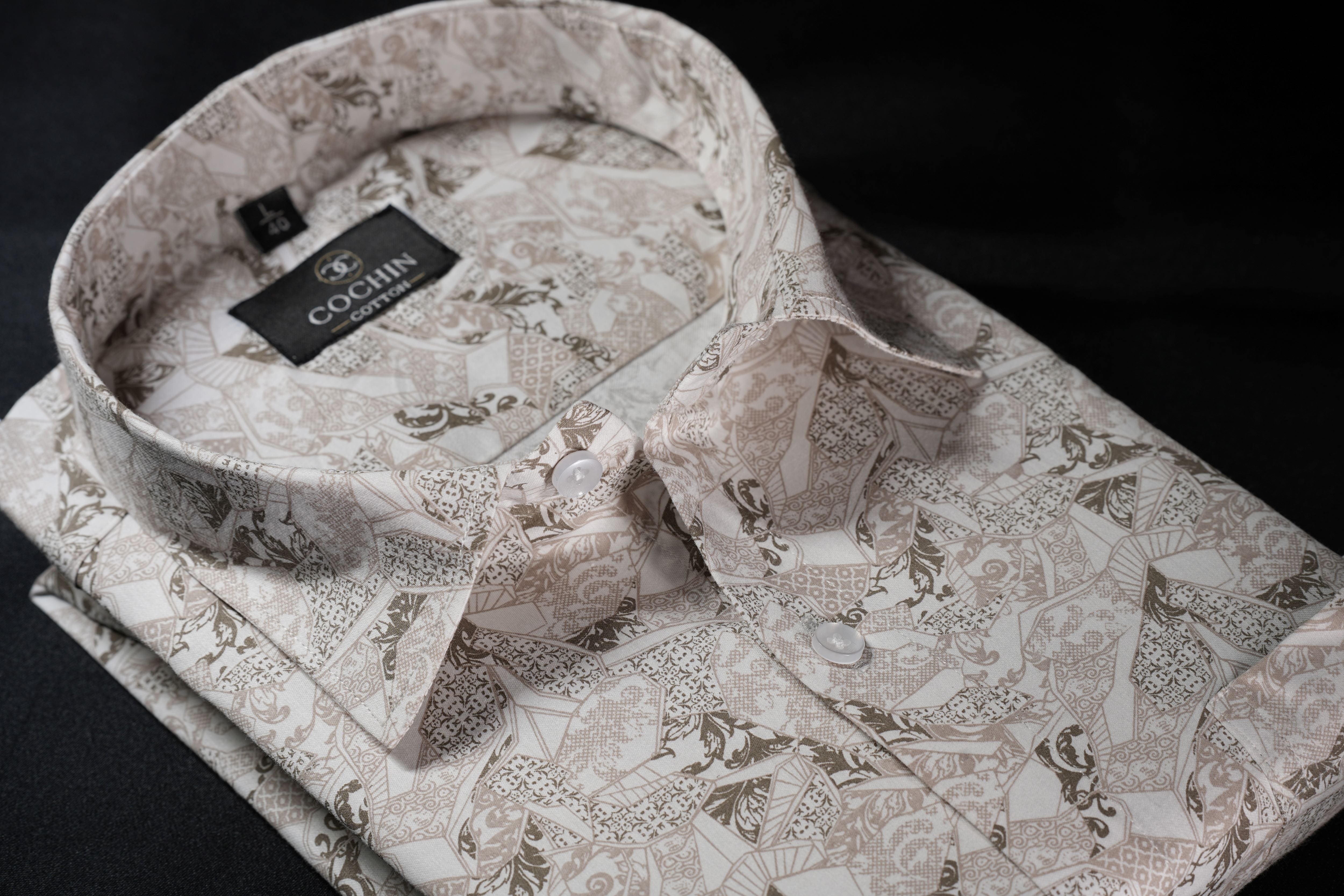 Floral patterned shirt with matching bow tie and pocket square on a dark background