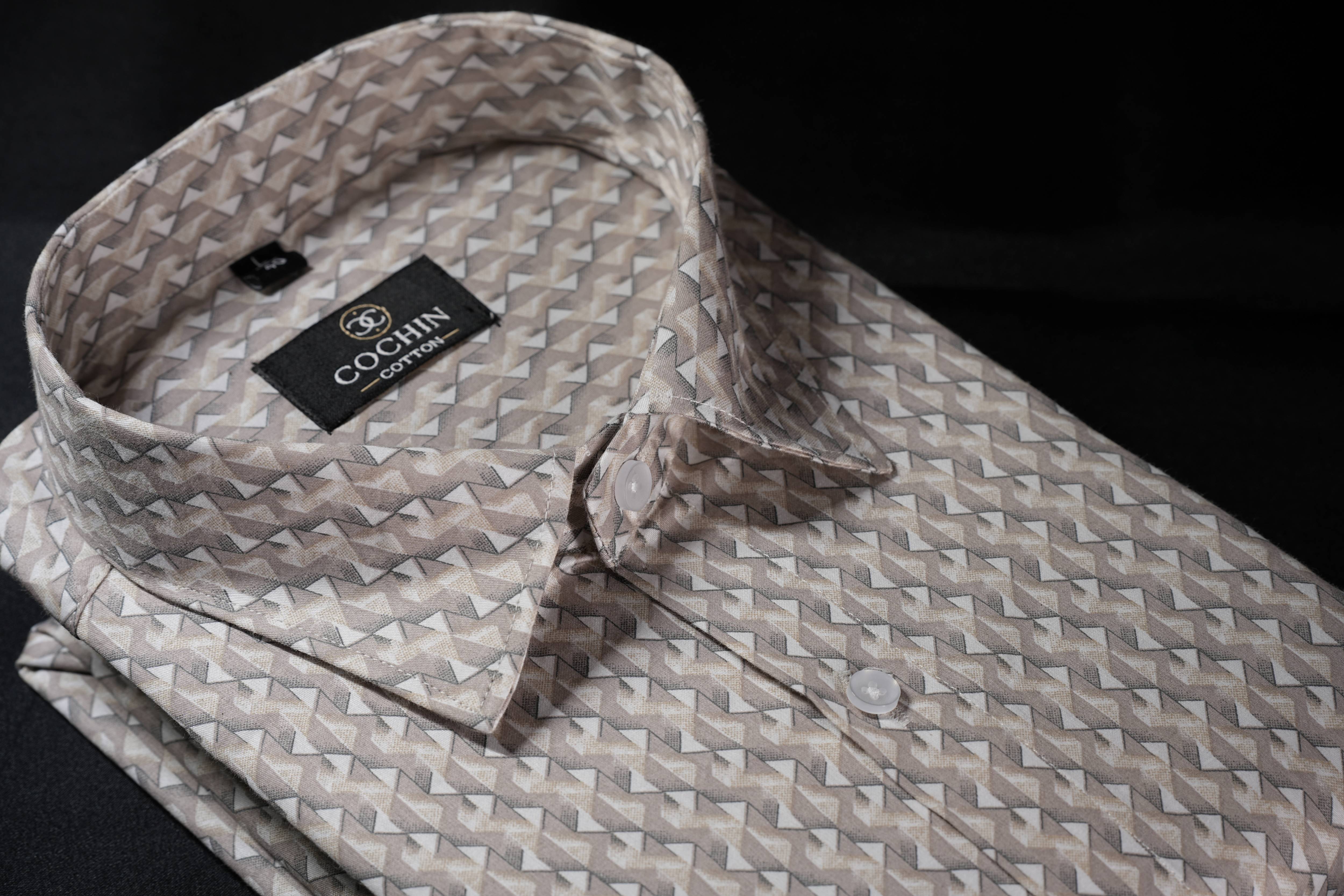 Folded patterned shirt with Cochin label on a black background