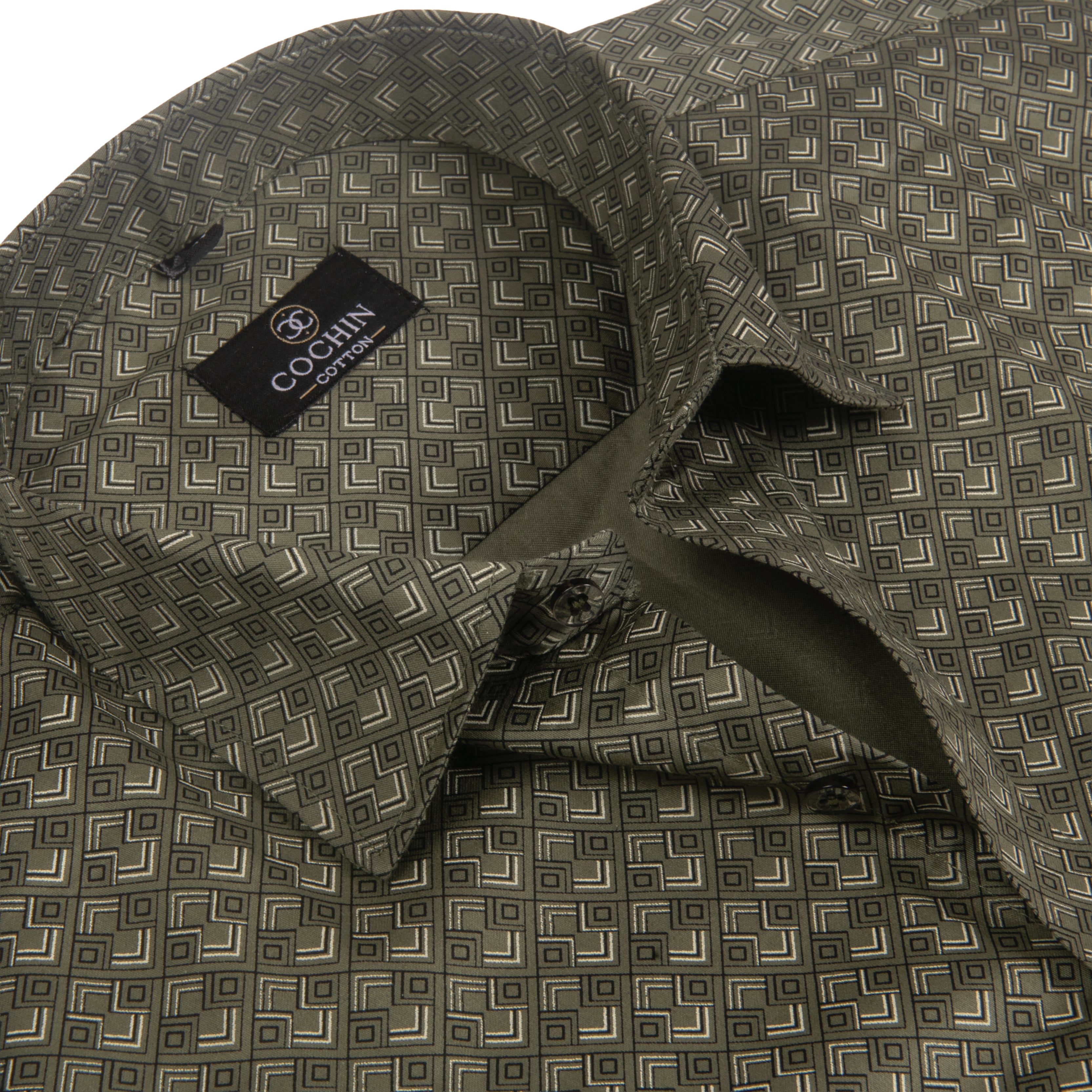 Close-up of a patterned dress shirt collar and upper chest area. The fabric has an olive green base with a repeating geometric diamond lattice pattern in beige and dark brown.