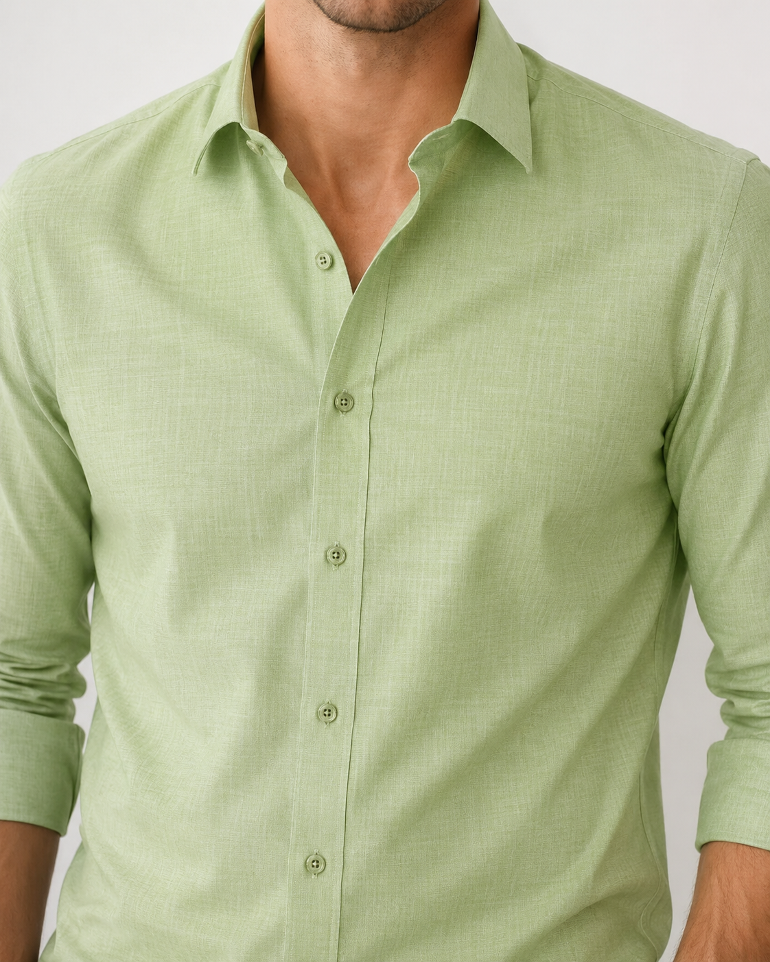 Green shirt worn by a person on a light gray background