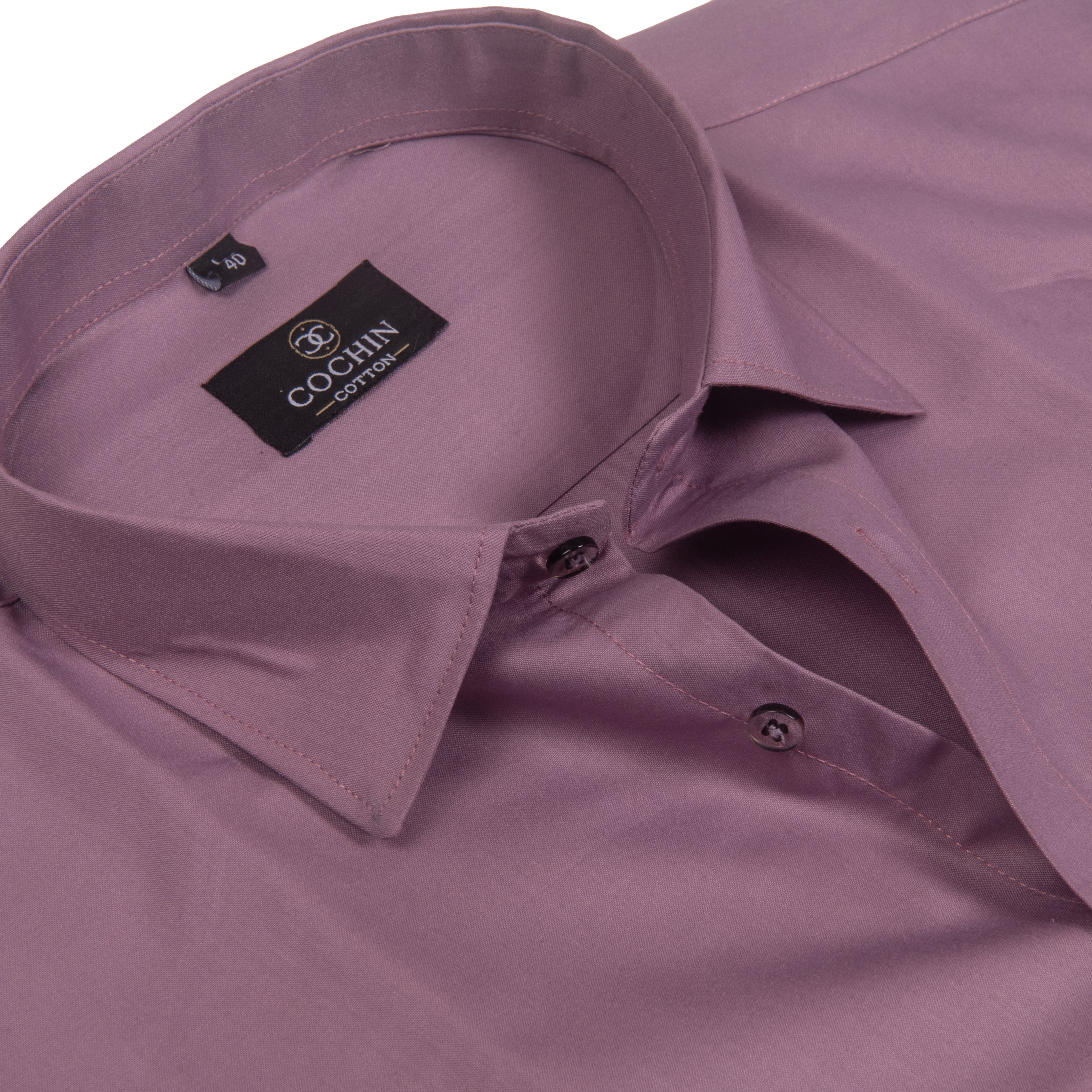 A close-up of a mauve-colored Cochin cotton dress shirt, showing the collar, inner label, and buttoned placket against a white background.
