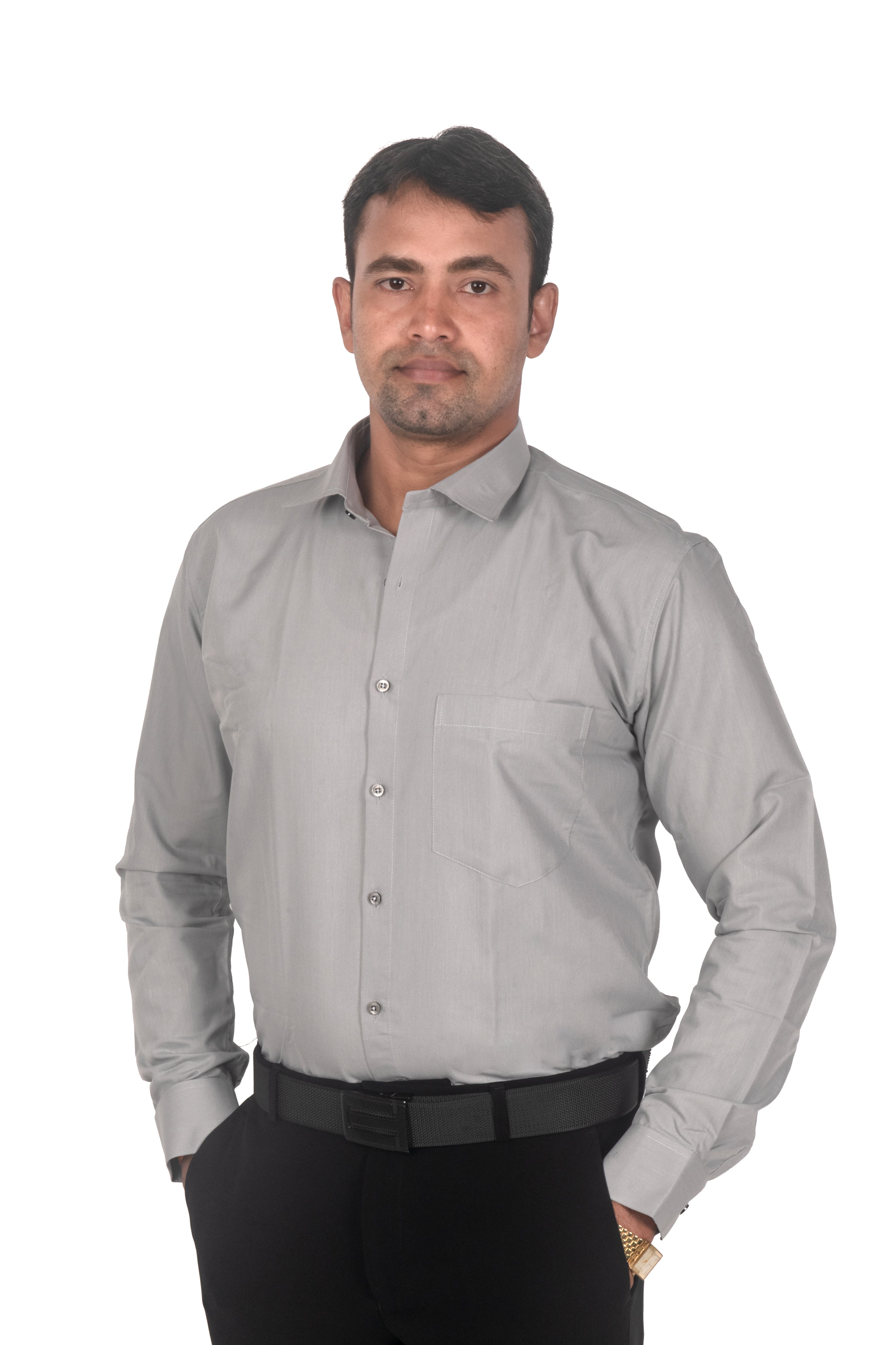 A man wearing a light gray long-sleeve button-down dress shirt with black trousers and a black belt, standing against a plain white background.