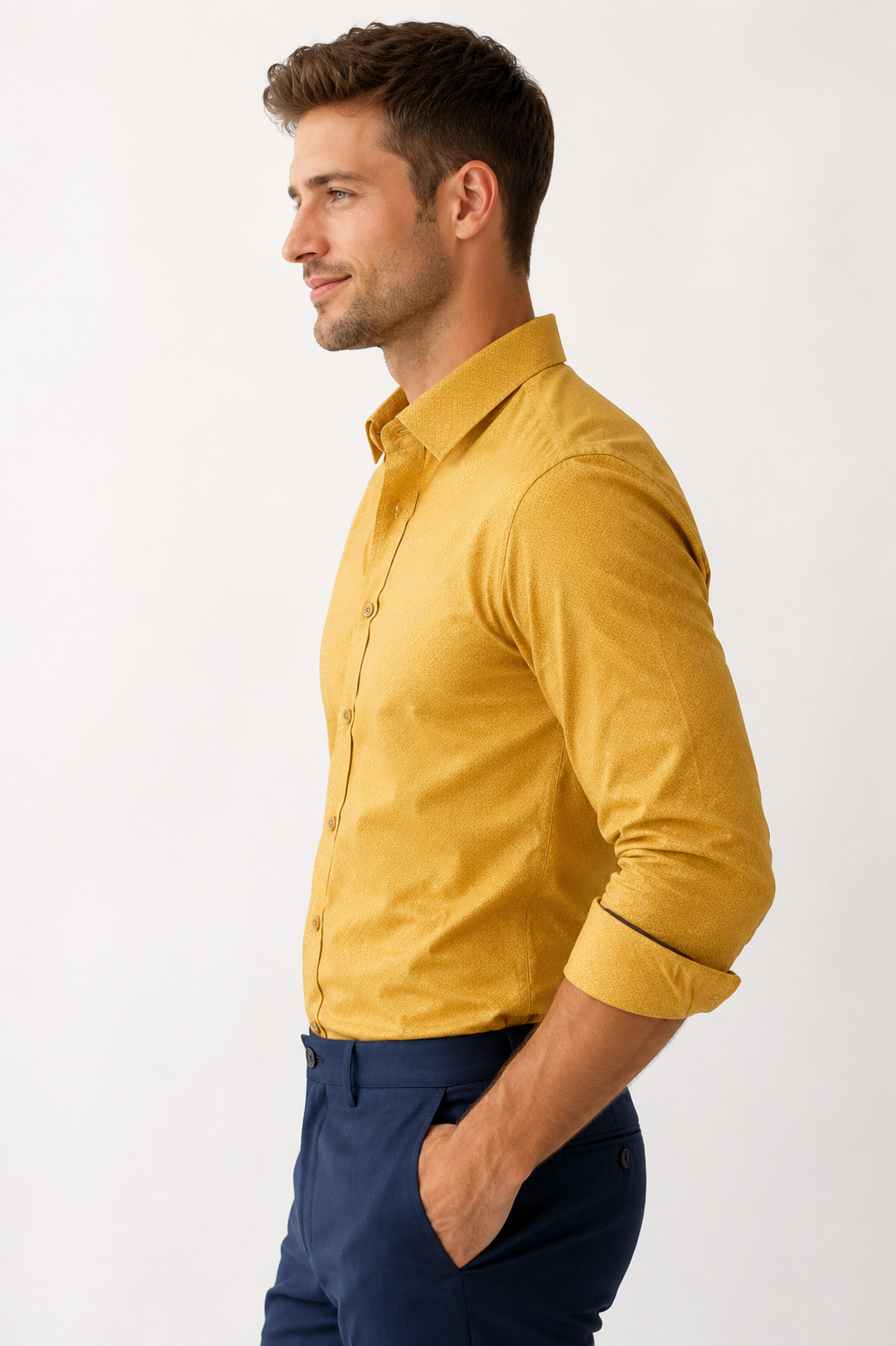 Man wearing a mustard yellow shirt and navy pants on a white background