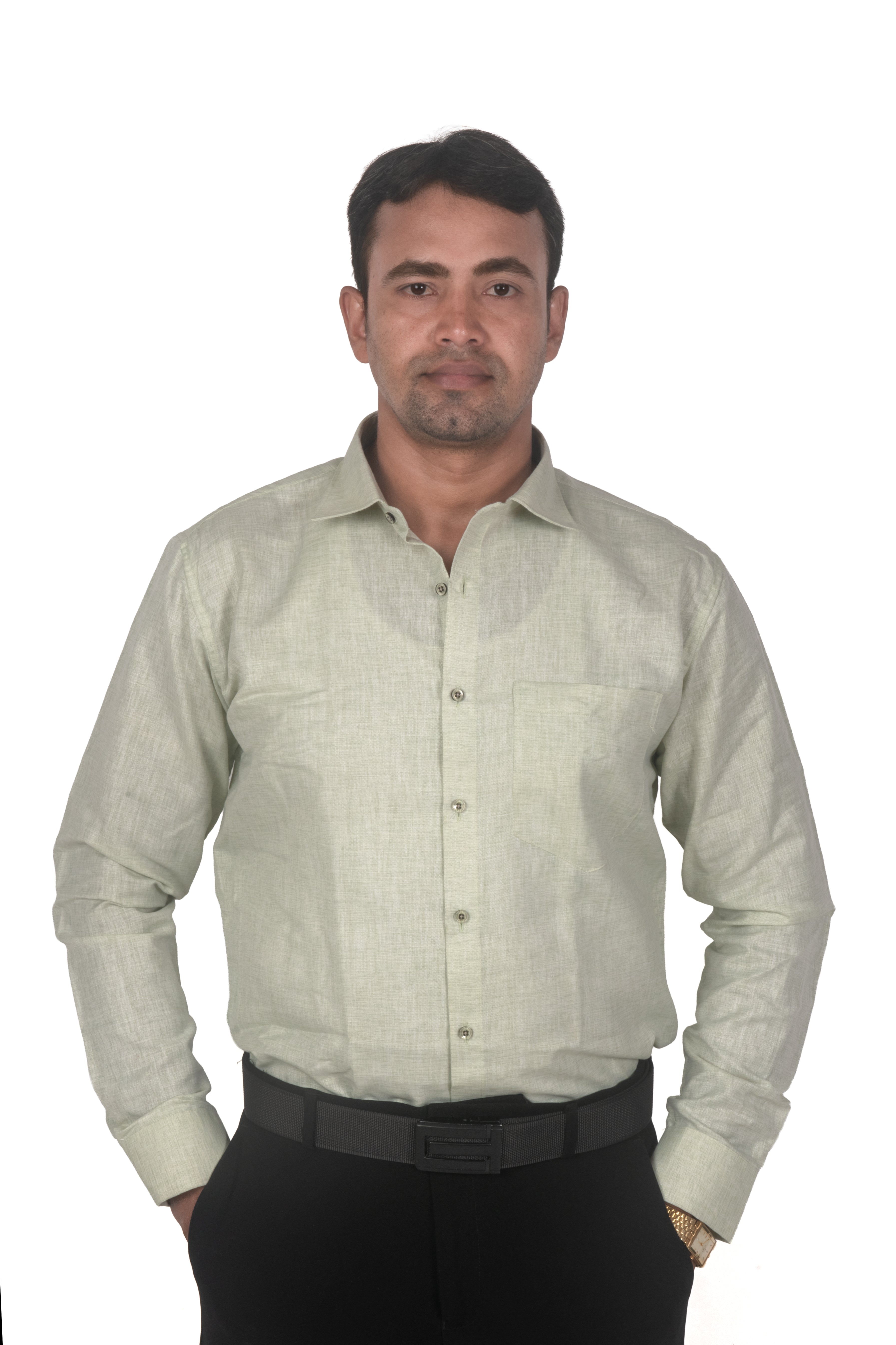A man wearing a light beige linen long-sleeve button-down shirt and black trousers, standing against a plain white background.