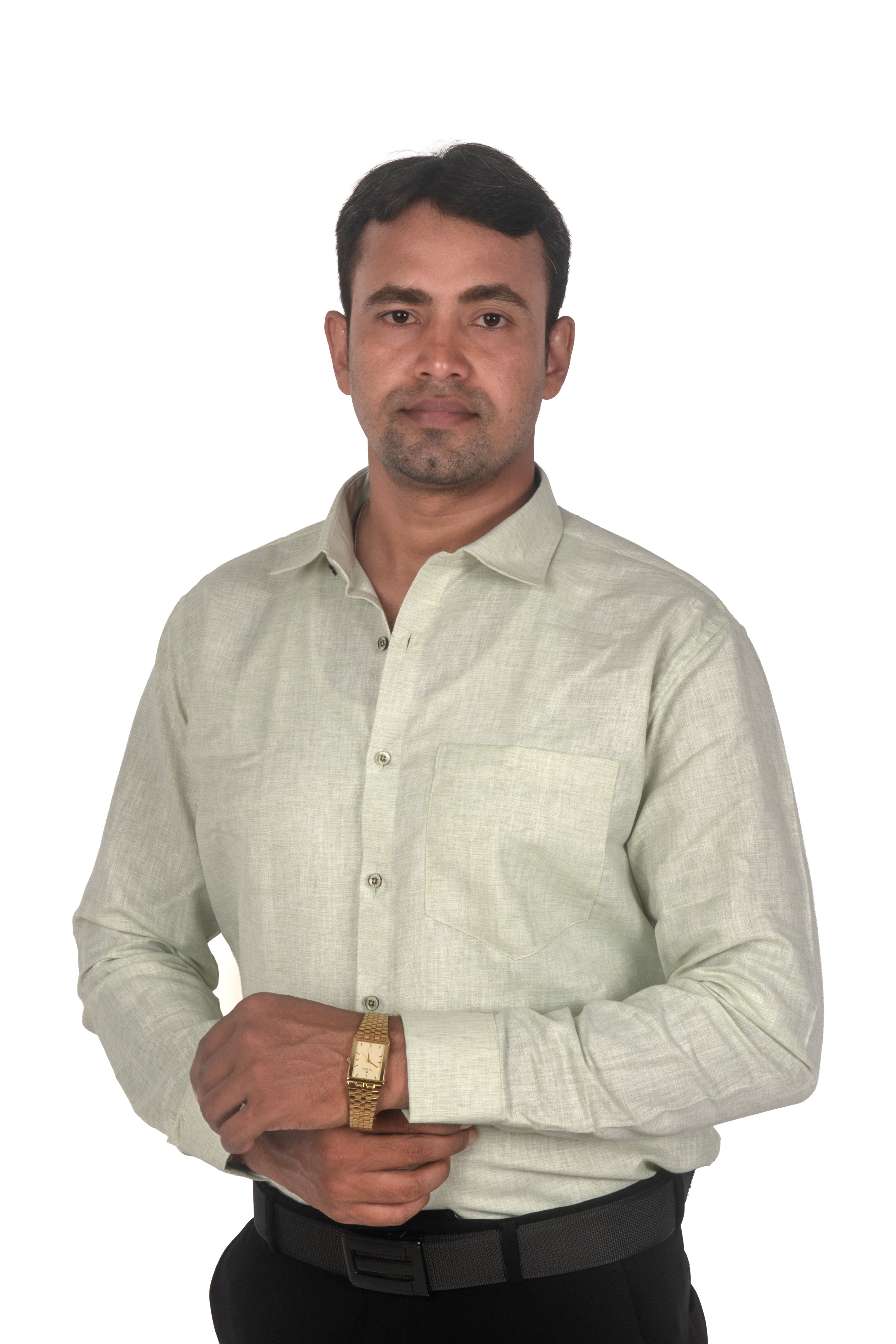 A man wearing a light beige linen long-sleeve button-down shirt, black trousers, and a gold watch, standing against a plain white background.