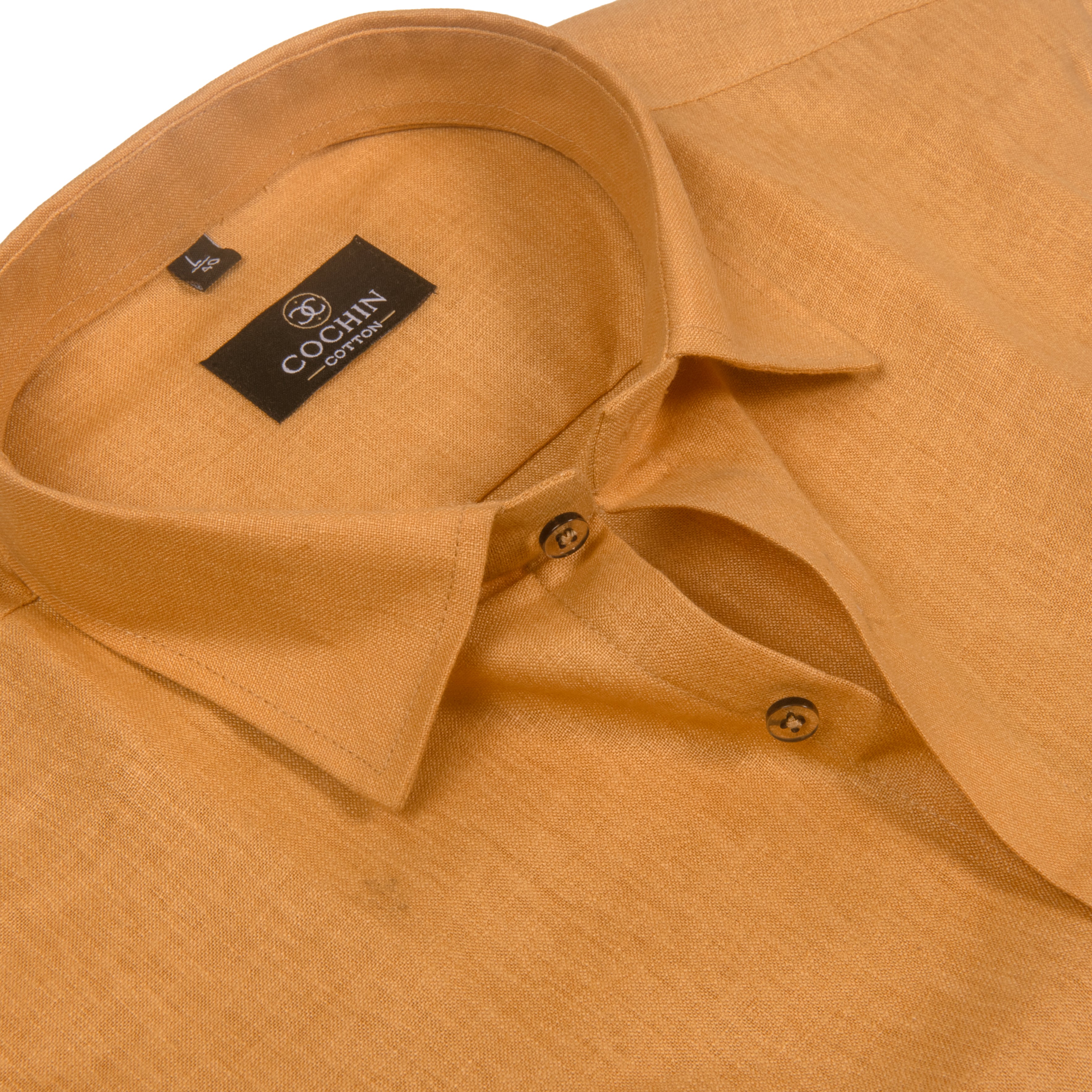 Close-up of a mustard yellow linen shirt collar with a black Cocihu Co., Ltd. brand label.