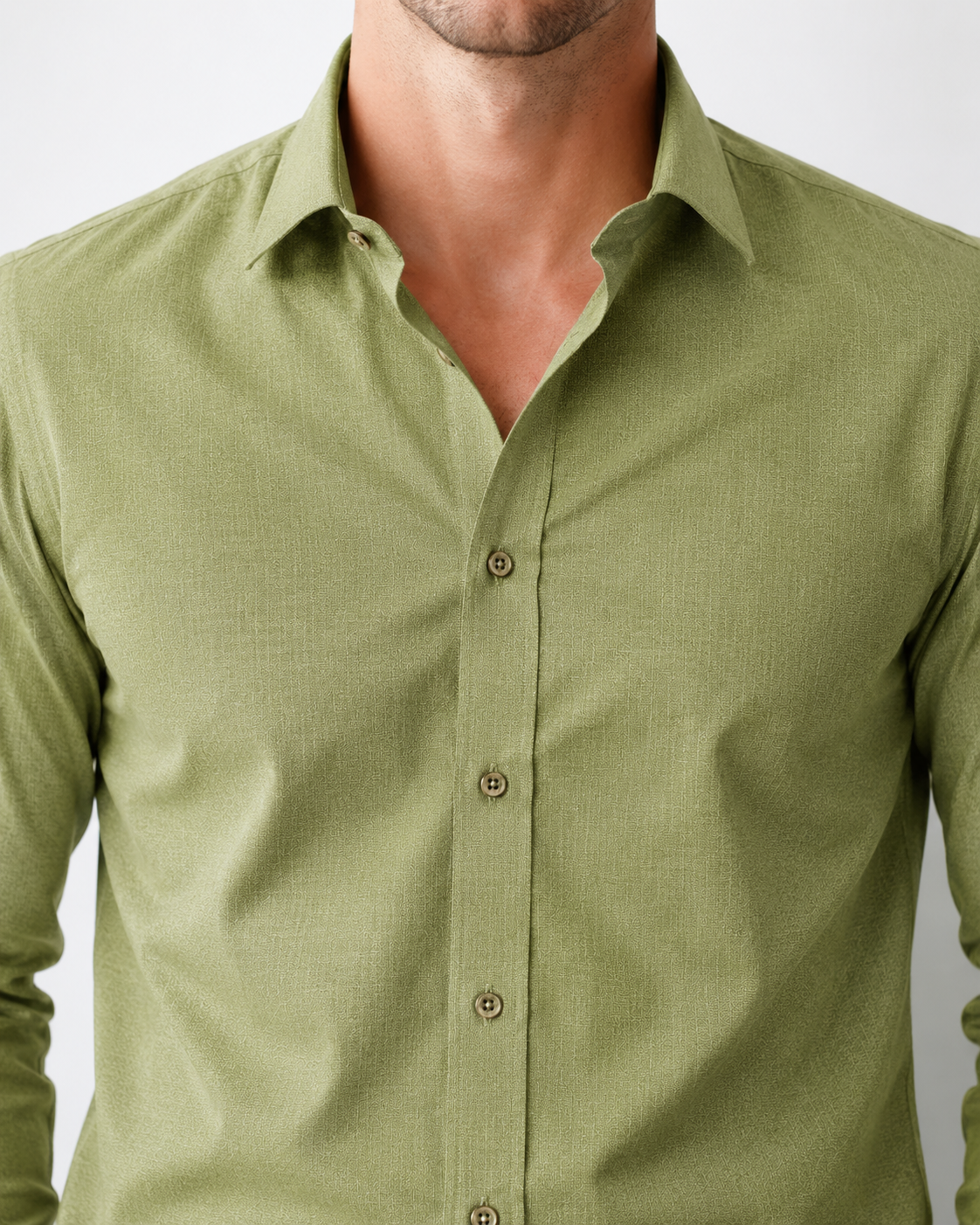 Green shirt worn by a person on a plain background