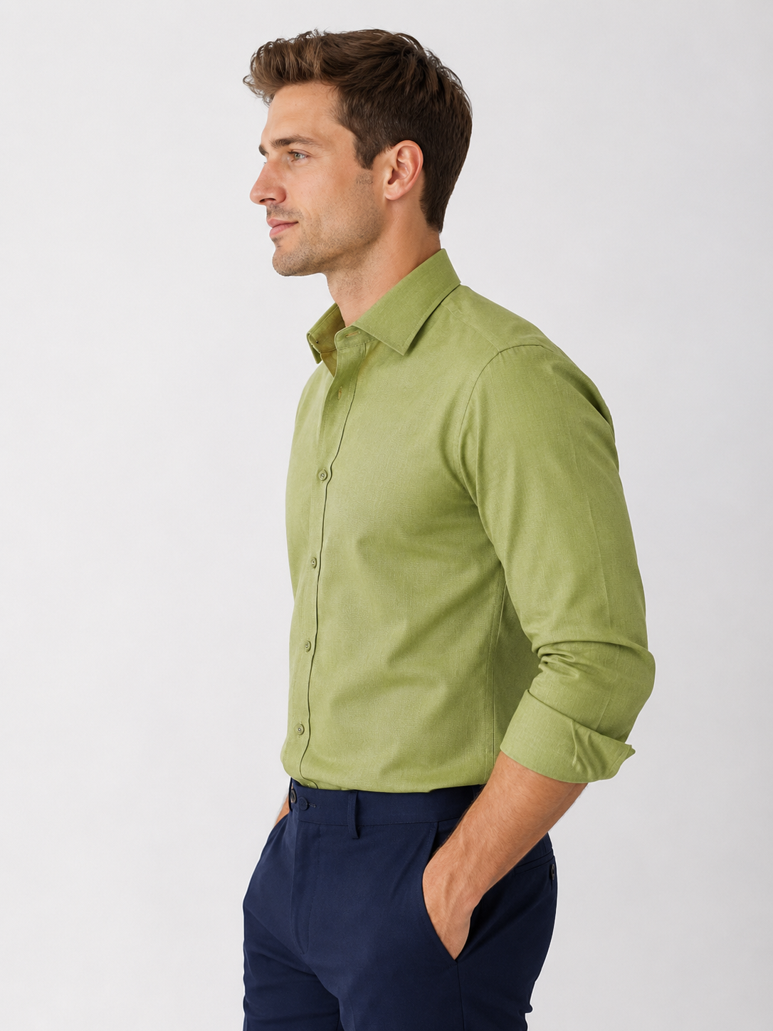 Man wearing a green shirt and navy pants on a white background