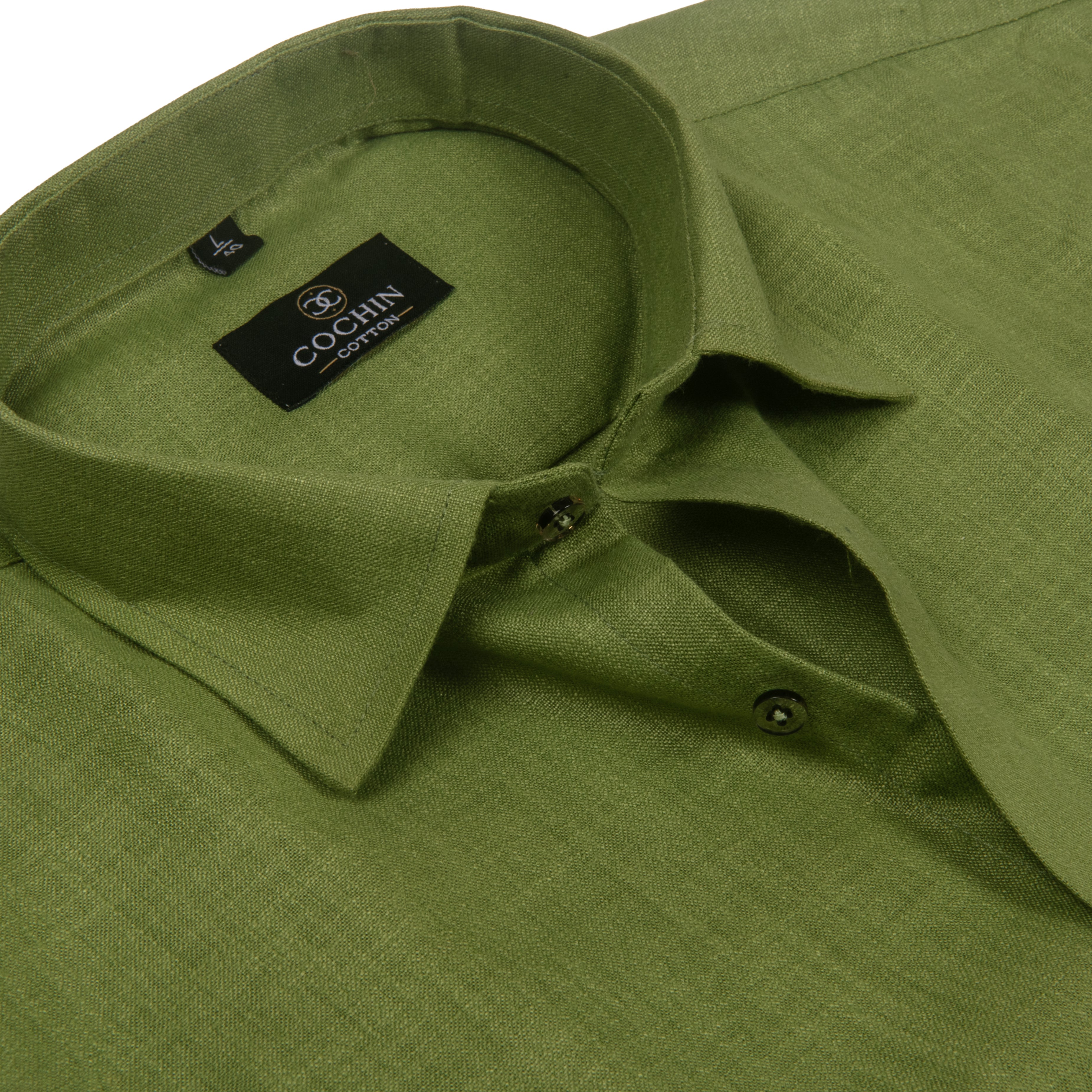 Close-up of an olive green linen shirt by Cochin Couture, showing the collar, buttoned placket, and textured fabric.