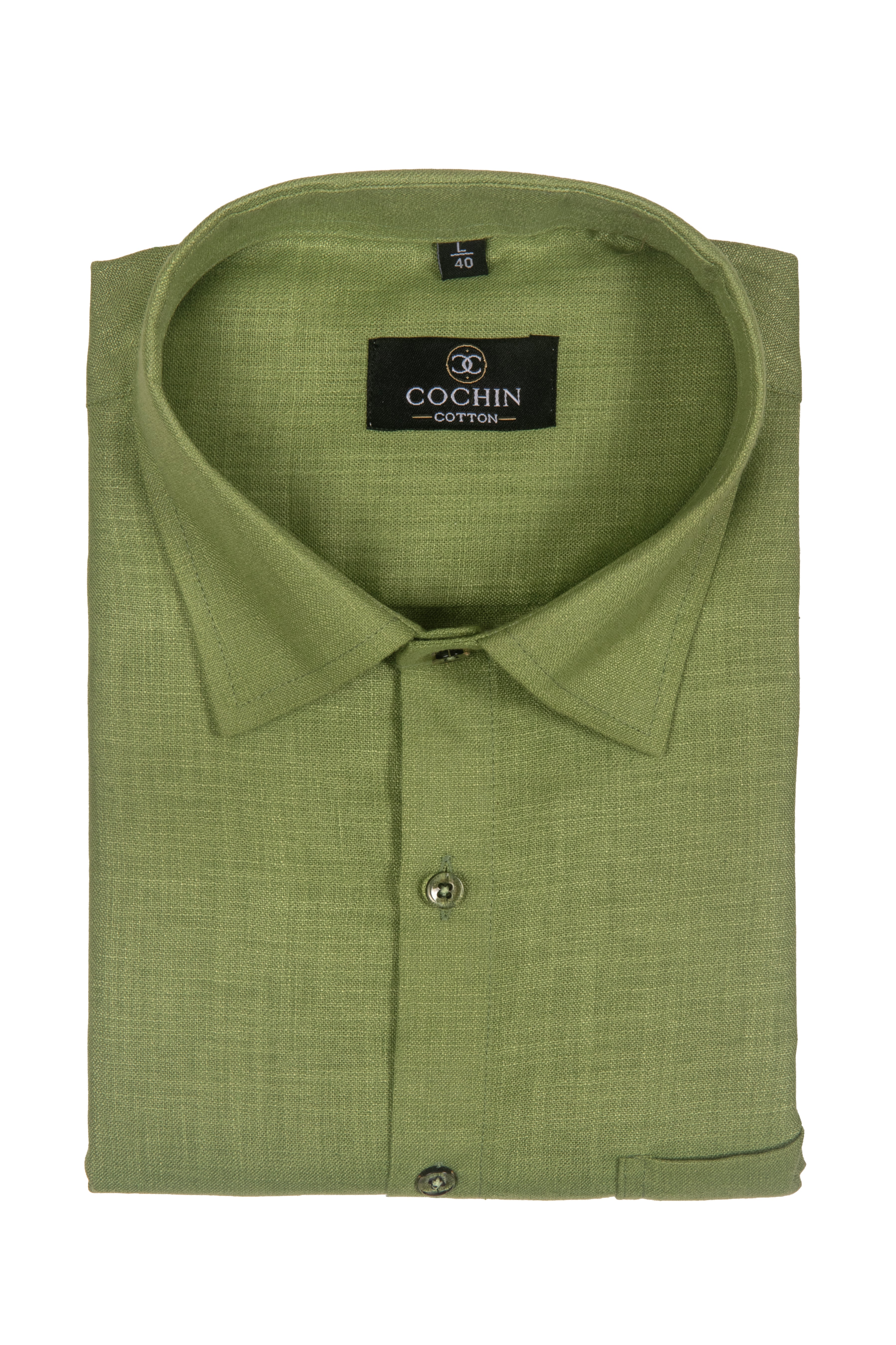 A folded light olive green linen shirt with a pointed collar and a black brand label reading 'COCHIN COTTON'.