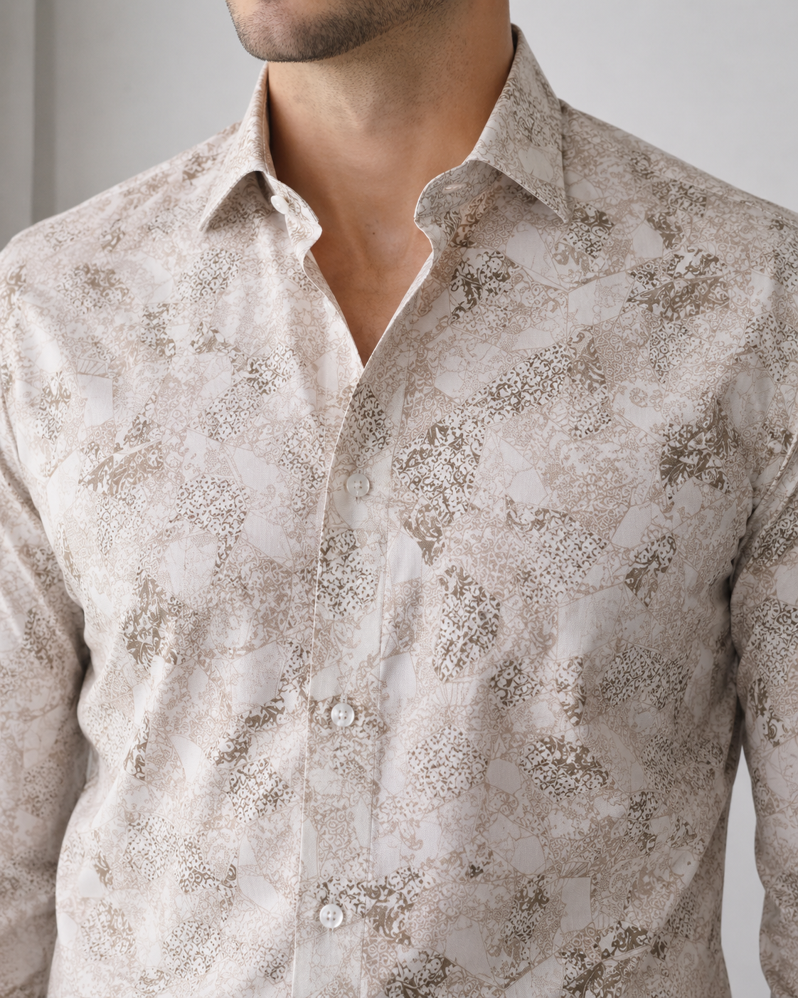 Close-up of a patterned shirt worn by a person against a neutral background