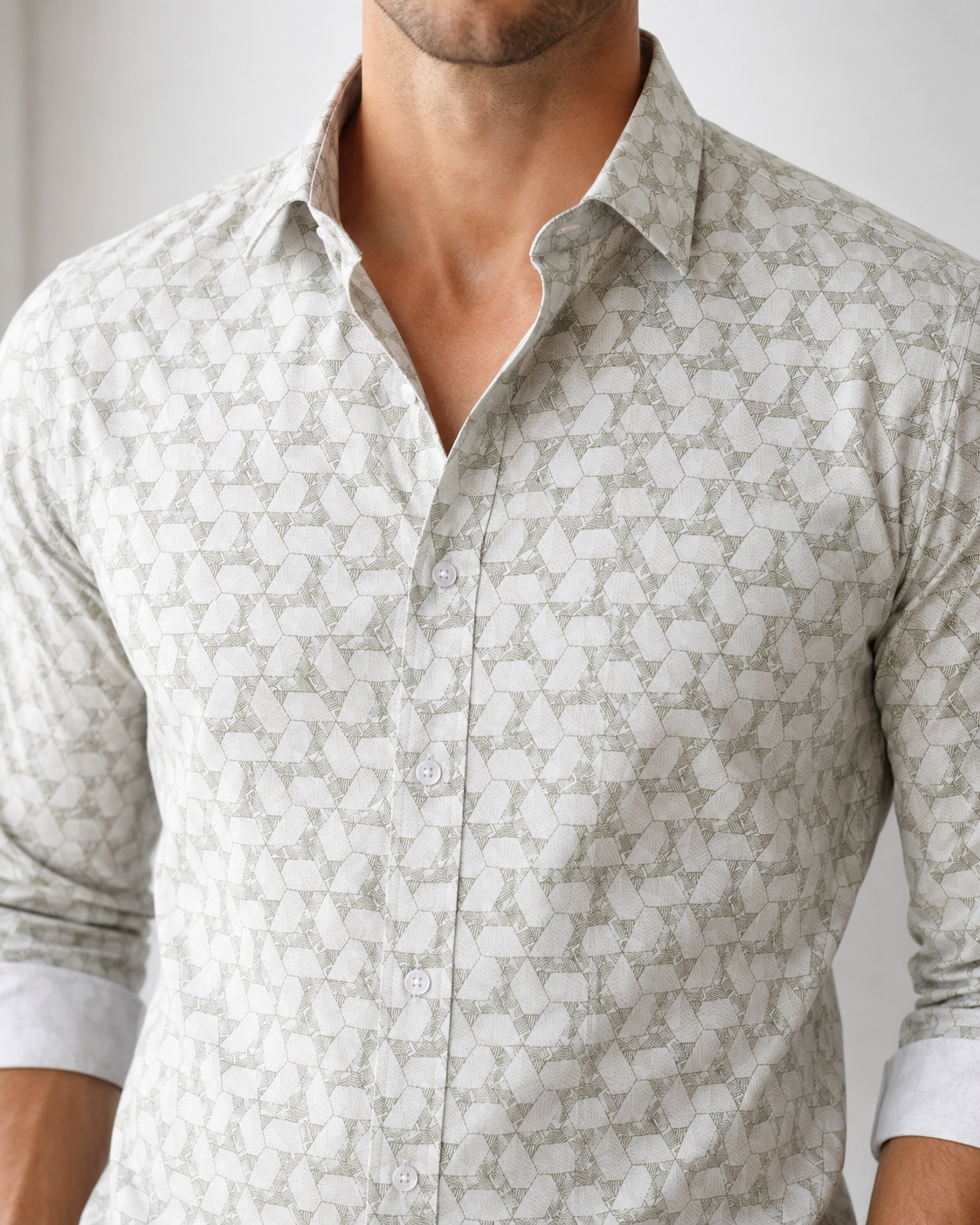 Man wearing a patterned shirt with a neutral background