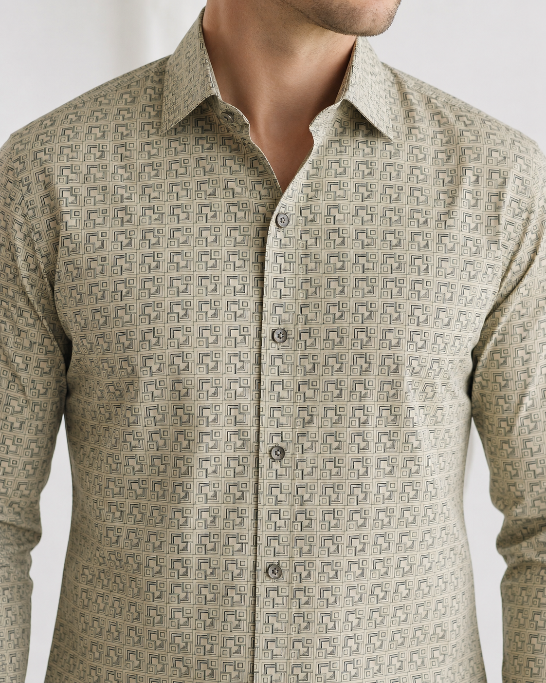 Beige patterned shirt worn by a person on a white background