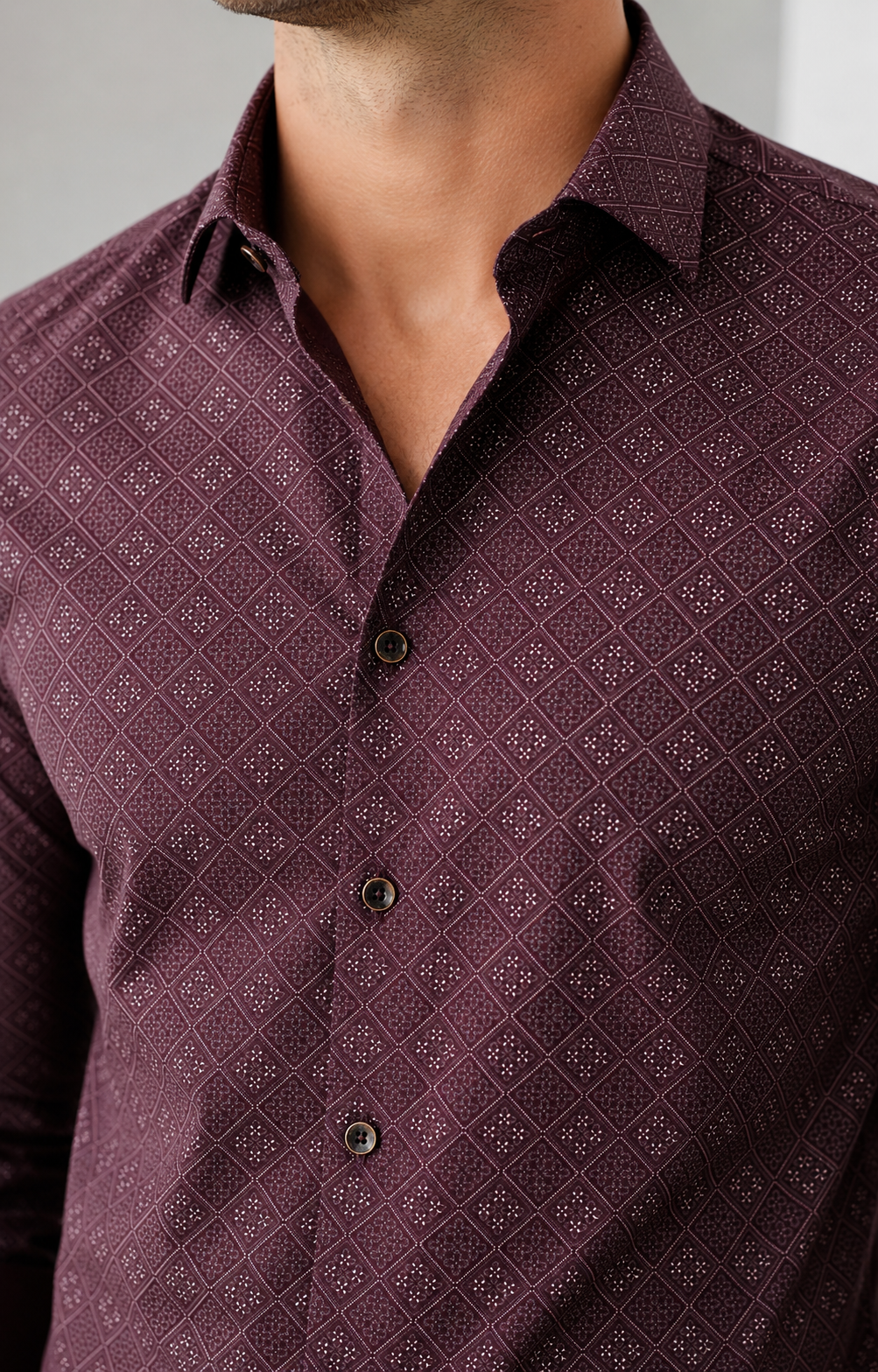 Close-up of a maroon patterned shirt worn by a person