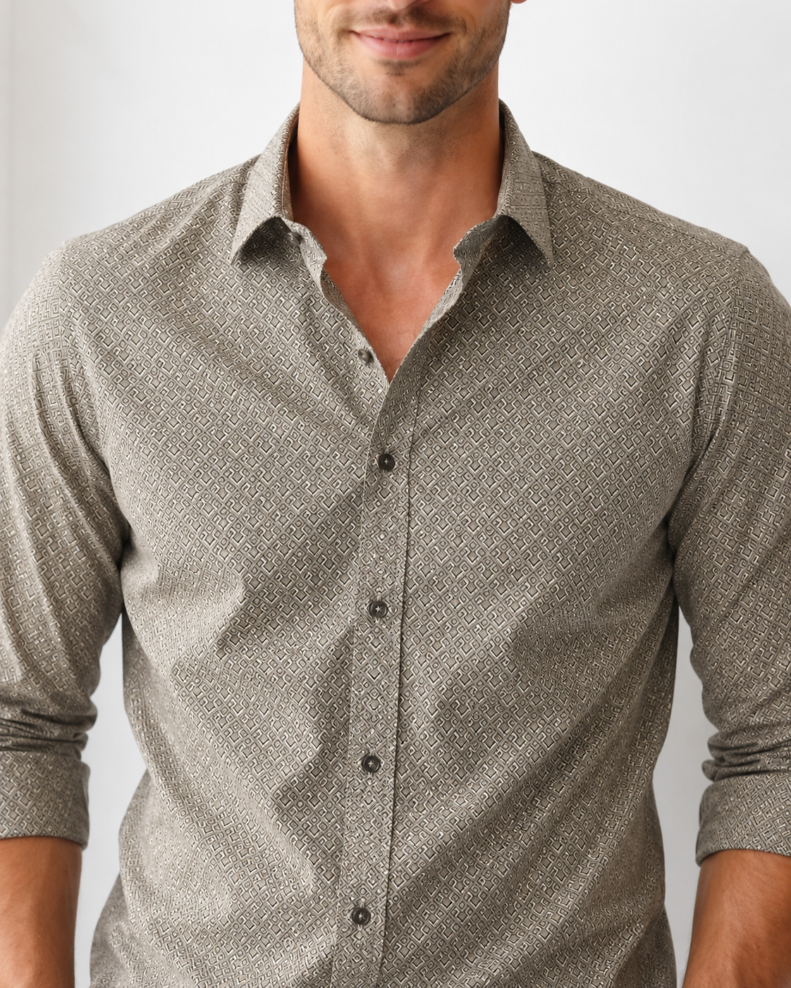 Man wearing a patterned gray shirt against a plain background
