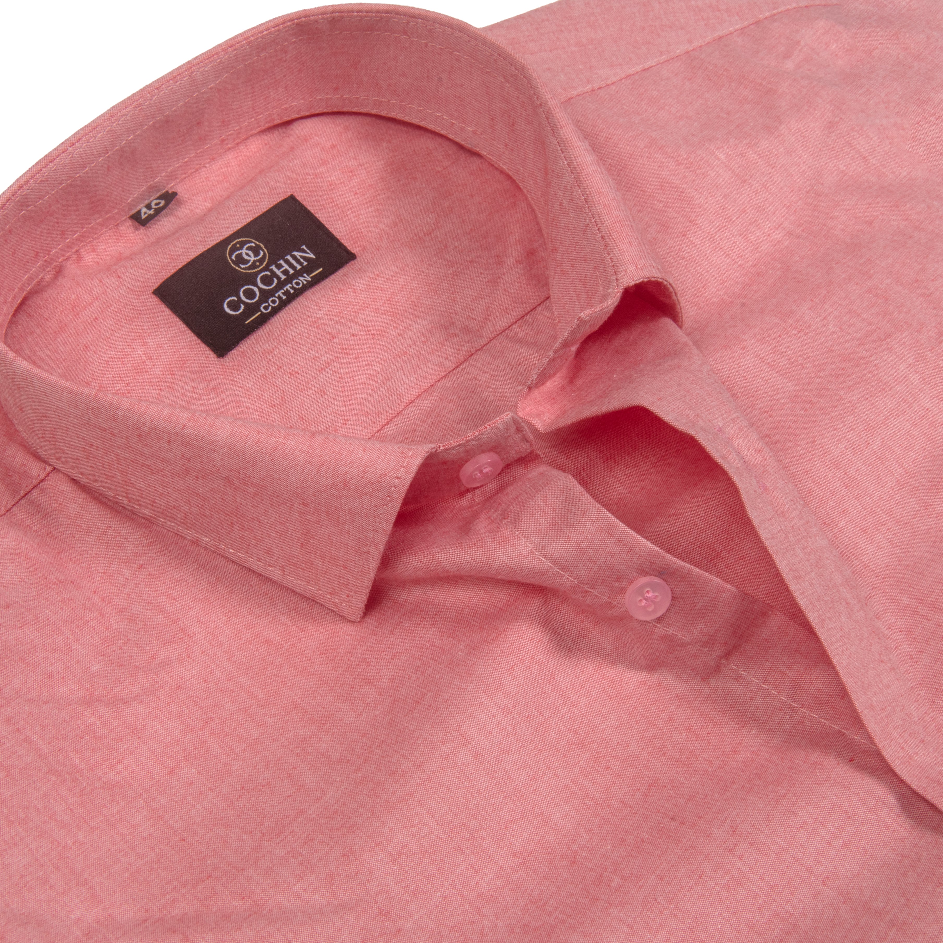 Close-up of a pink Cochin cotton shirt with a pointed collar and visible brand label.