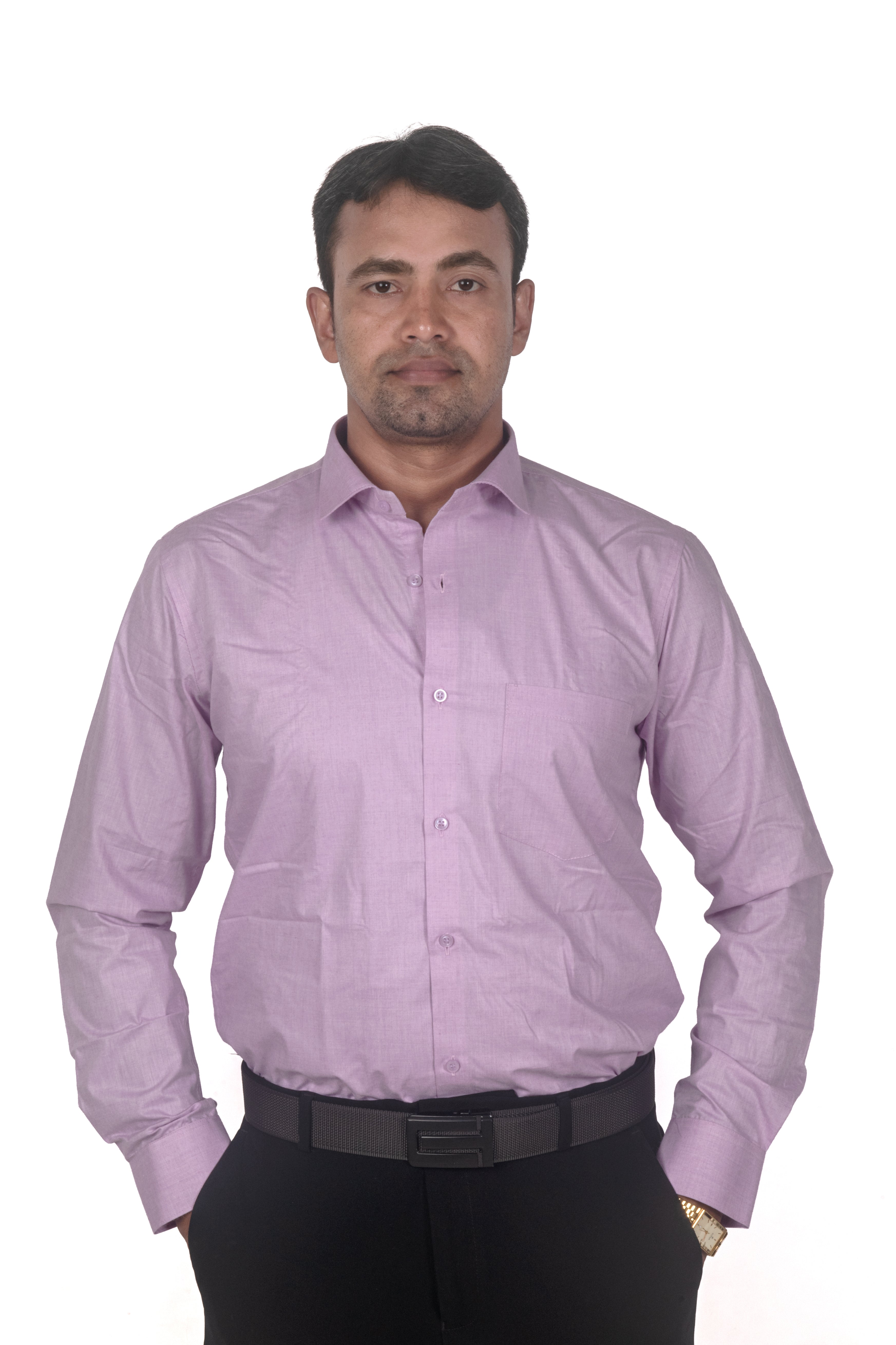 A man wearing a light purple long-sleeve button-down dress shirt with black trousers and a black belt, standing against a plain white background.