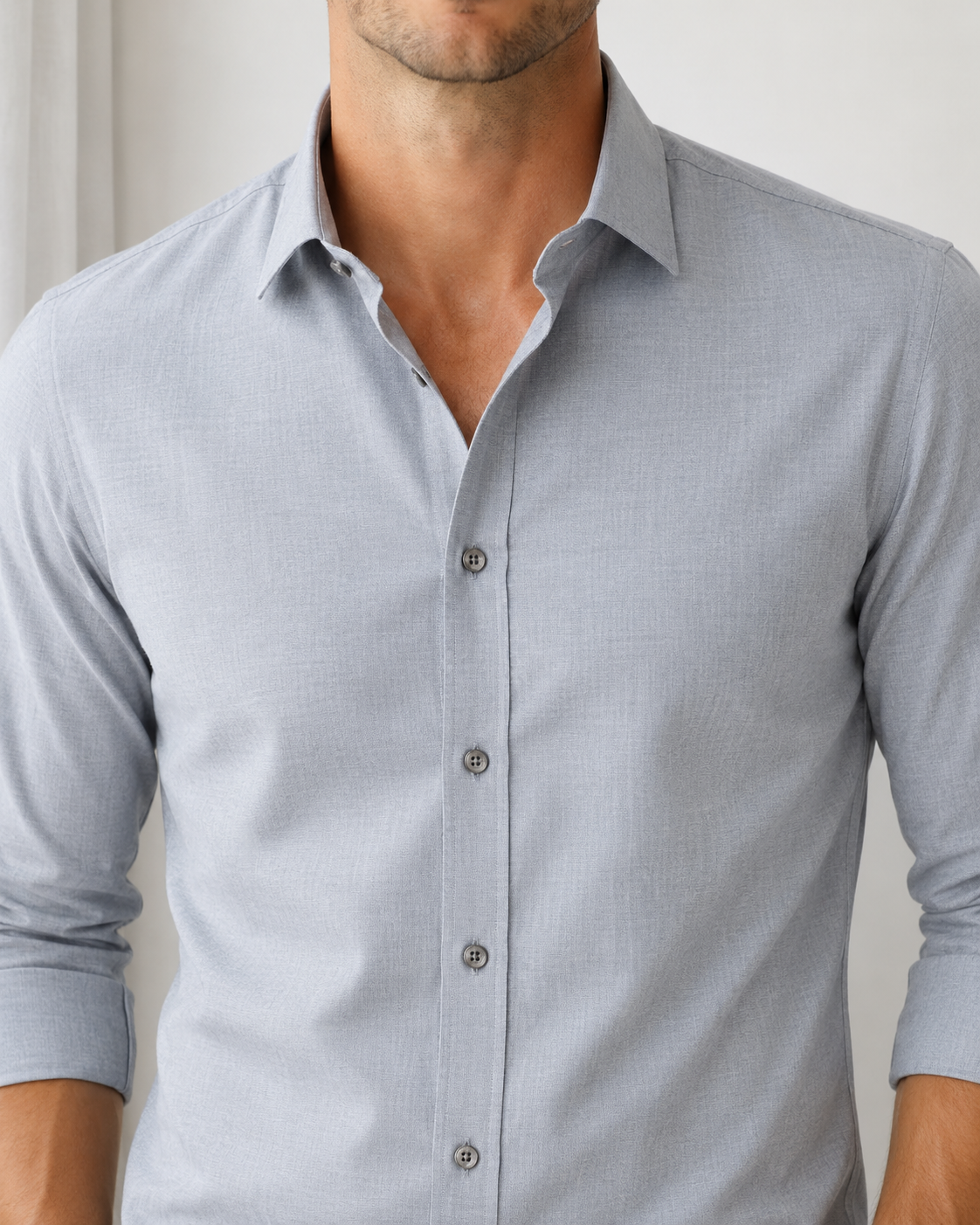 Light gray button-up shirt worn by a person against a neutral background