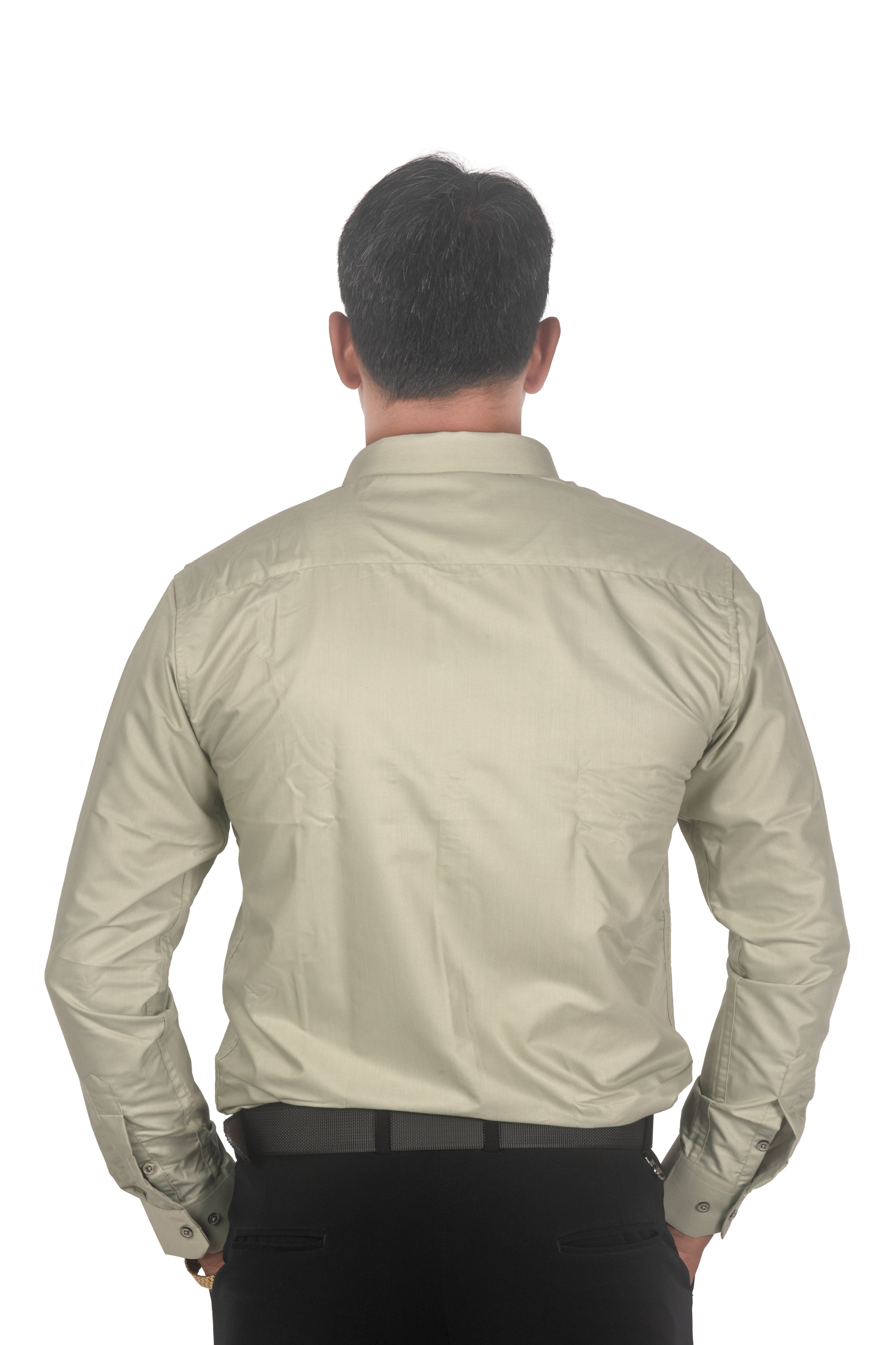A man viewed from behind wearing a light beige long-sleeve button-down shirt and black trousers, isolated on a white background.