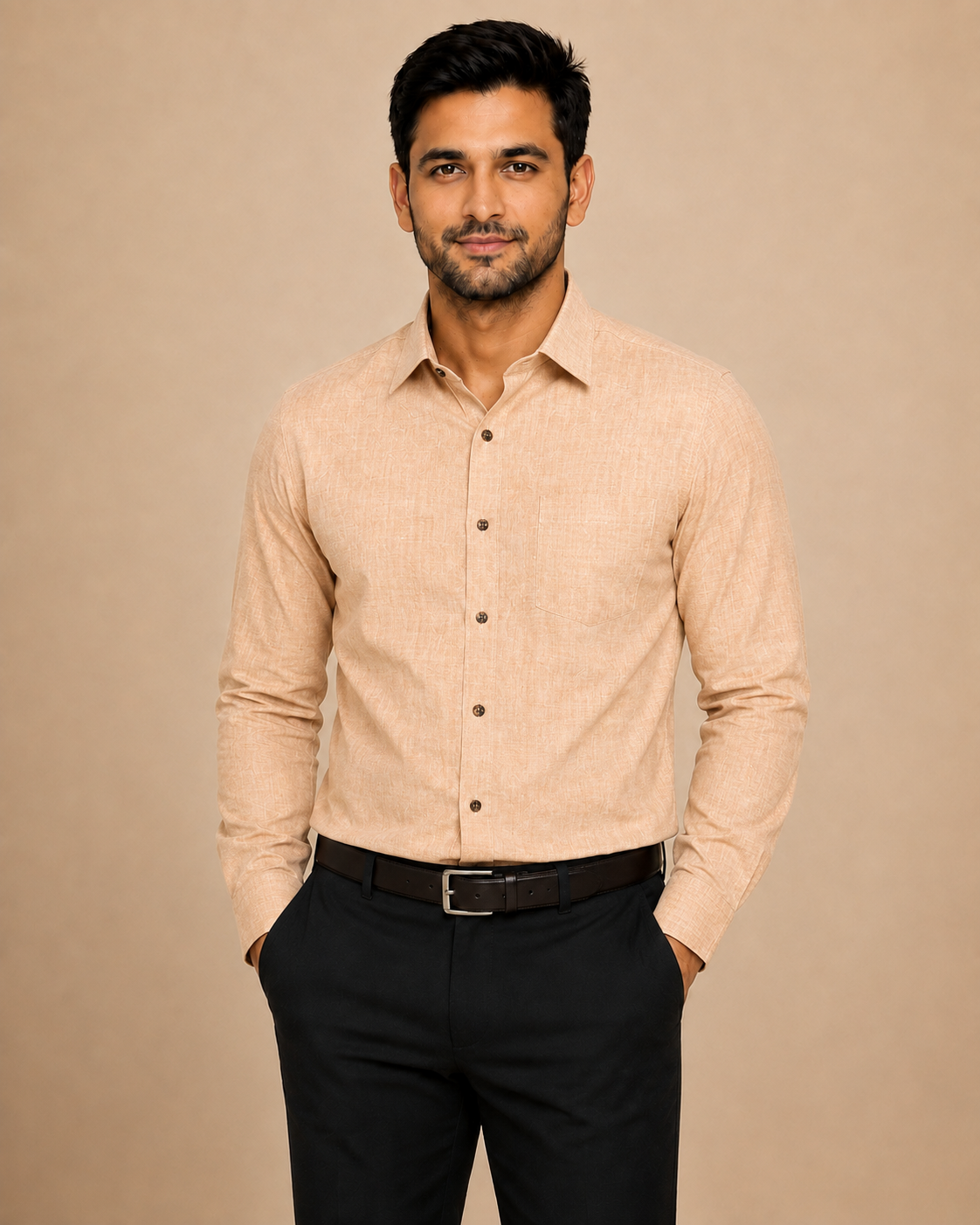 A man wearing a light beige long-sleeve button-down shirt and black trousers, standing against a solid beige background.