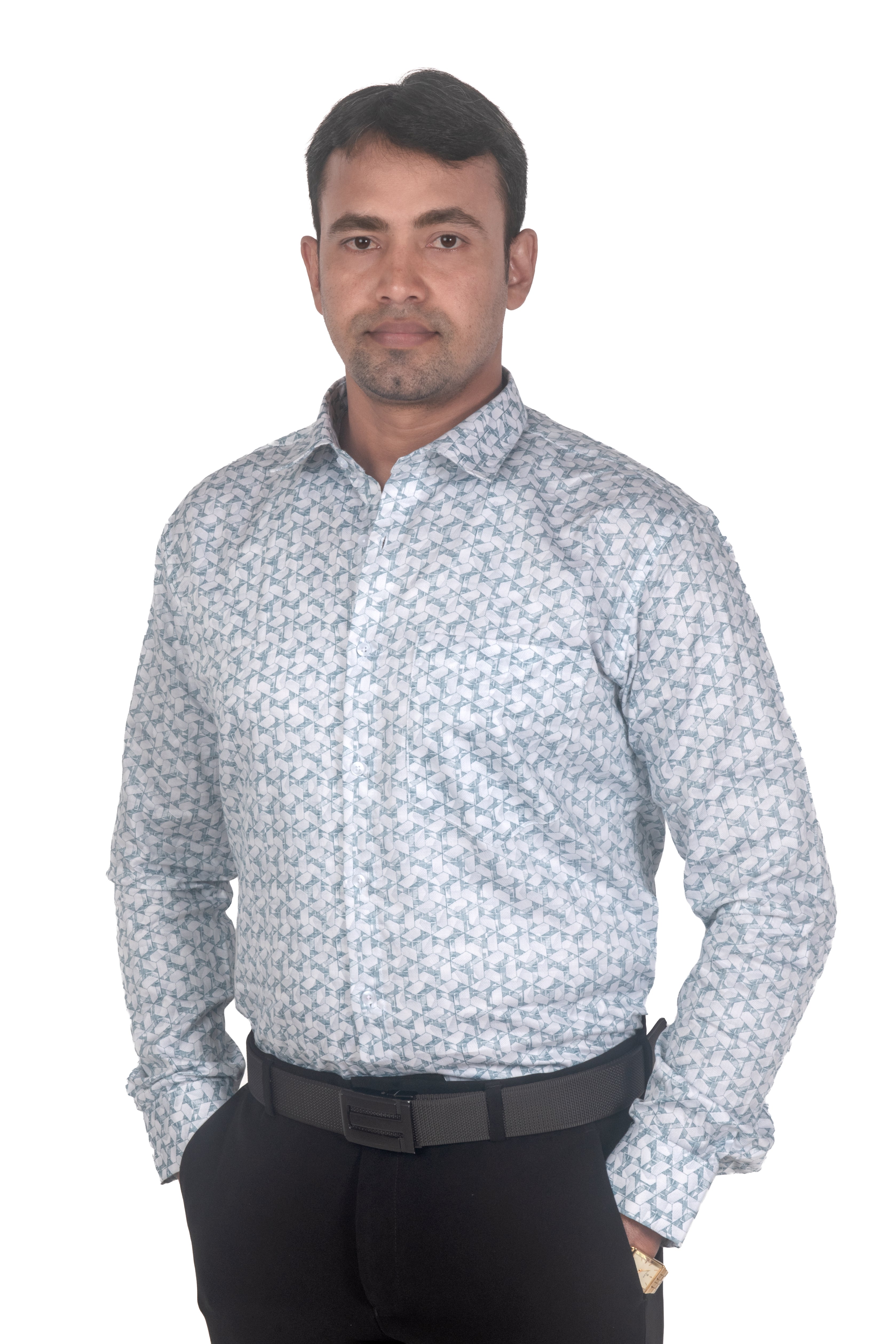 A man wearing a light blue and white patterned long-sleeve button-down shirt with black trousers, standing against a plain white background.