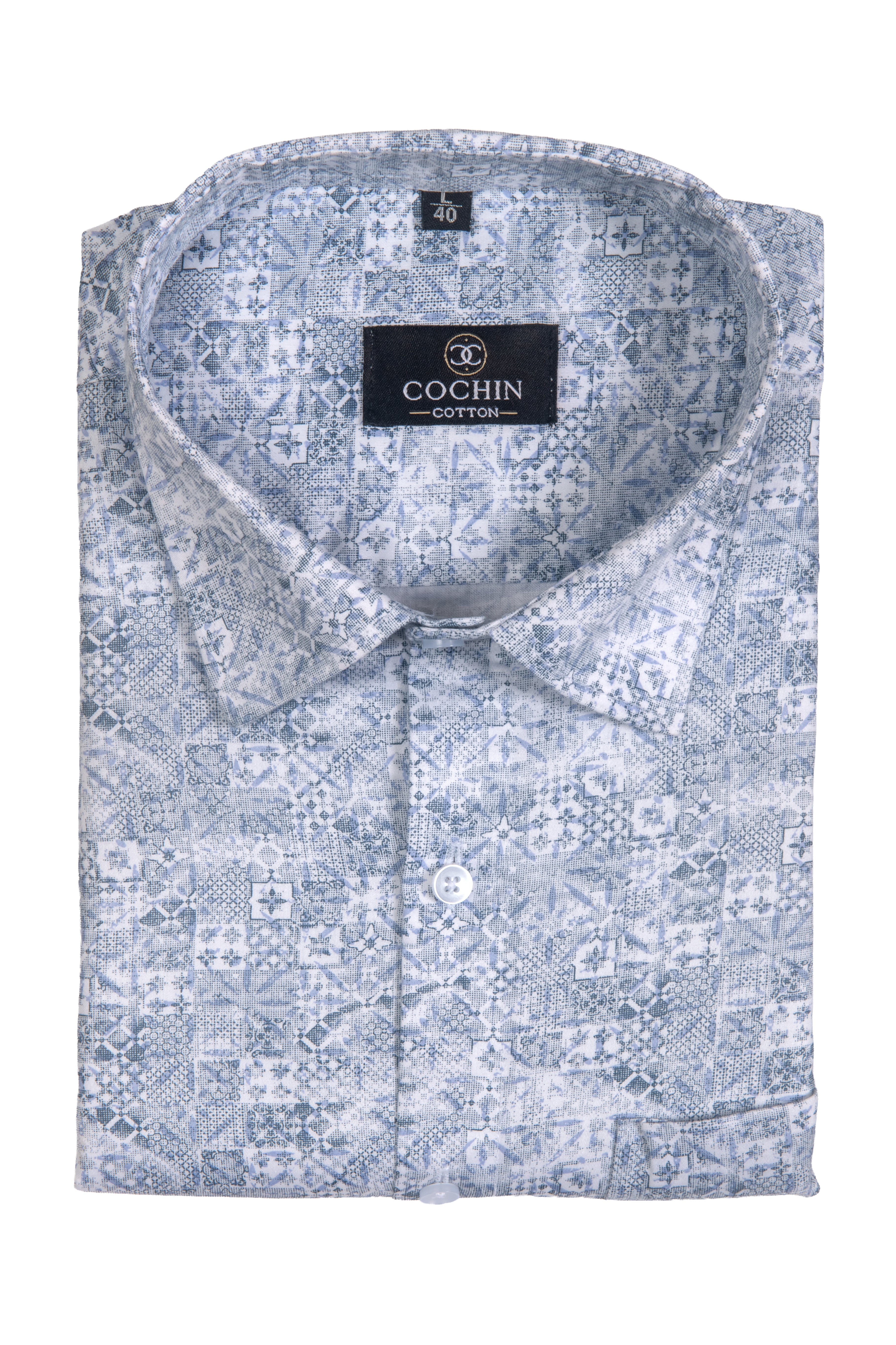 A folded light blue and white patterned dress shirt with a pointed collar and a black Cochin Cotton brand label on the inside neck, shown against a plain white background.
