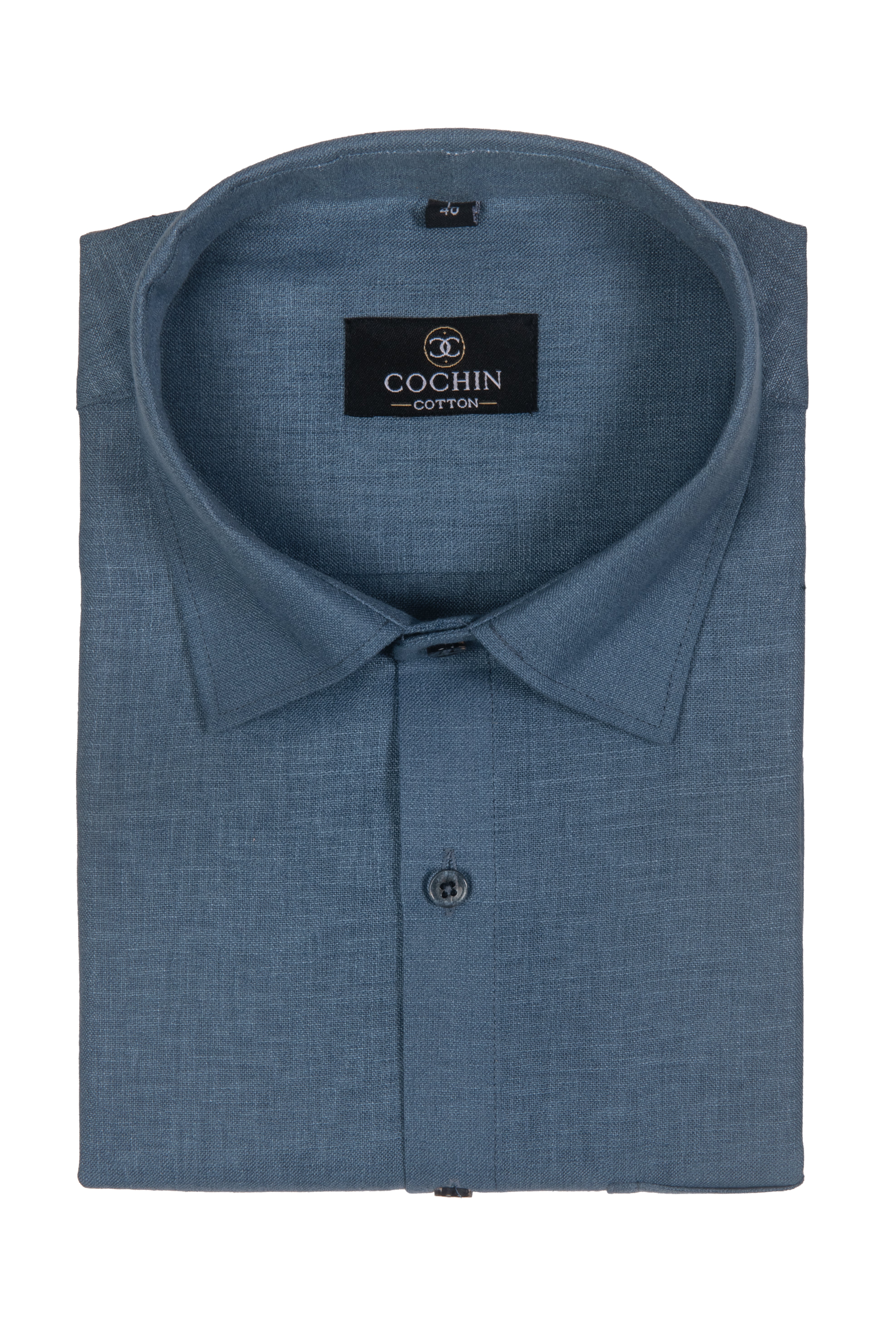 A folded blue long-sleeve dress shirt with a textured linen-like weave, featuring a pointed collar, button-down front, and a black neck label that reads 'COCHIN CLOTHING'.