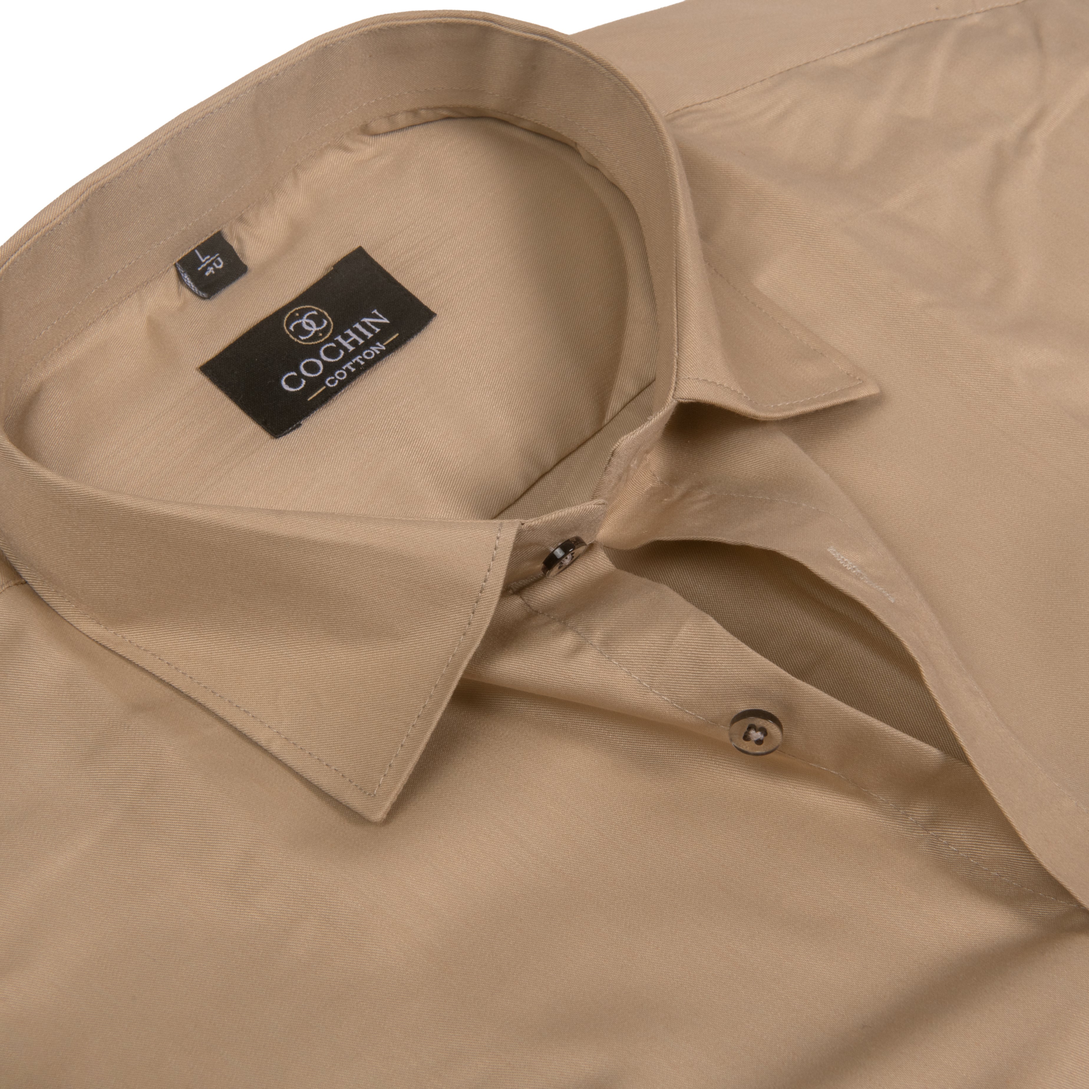 Close-up of a beige button-down shirt collar with a visible black brand label reading COCHIN CLOTHING.