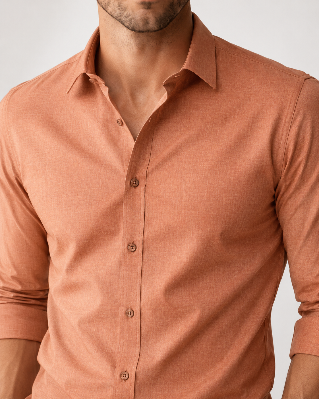 Man wearing a brown button-up shirt against a plain background
