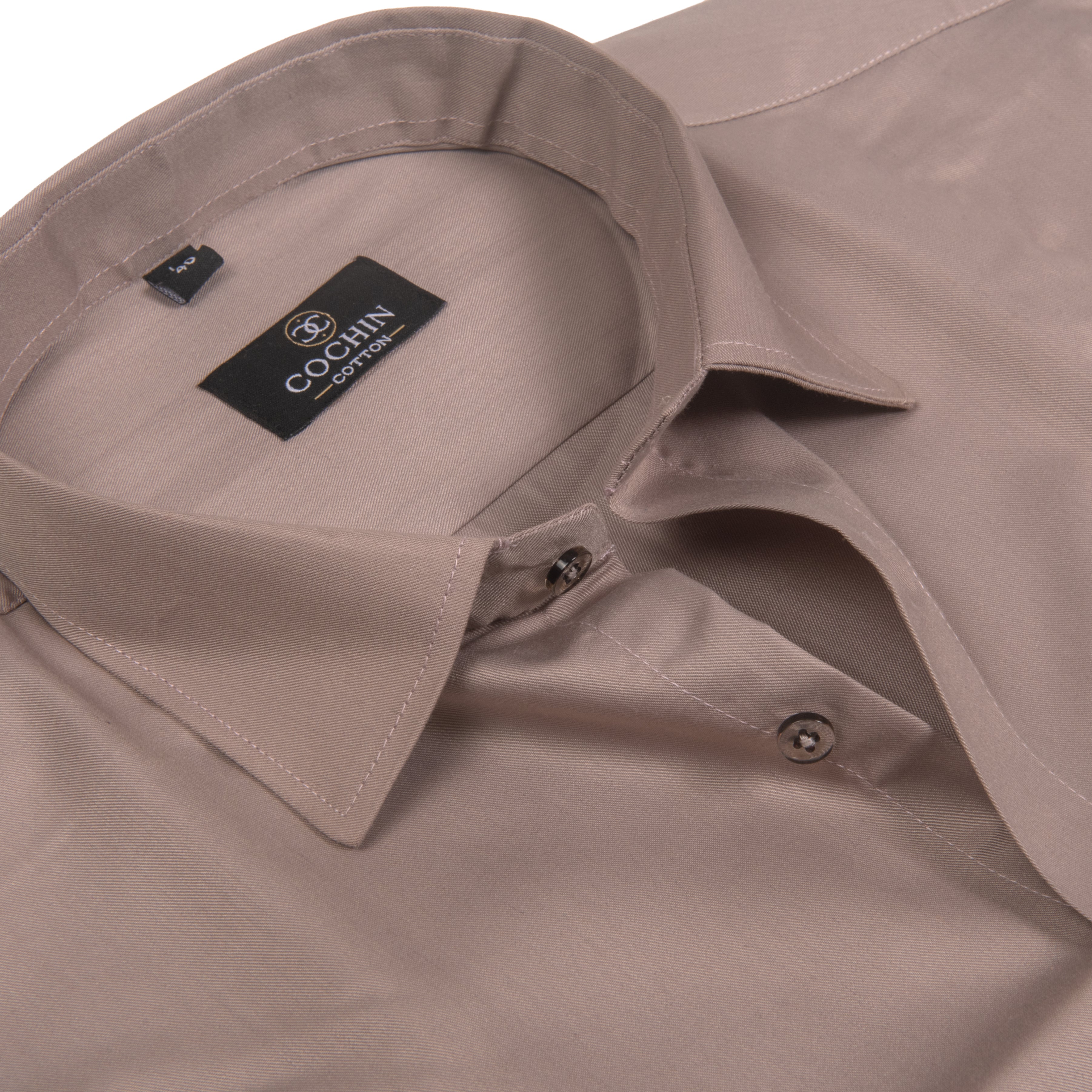 Close-up of a light taupe-brown dress shirt by COCHIN CLOTHING, showing the collar, inner neck label, and button placket.