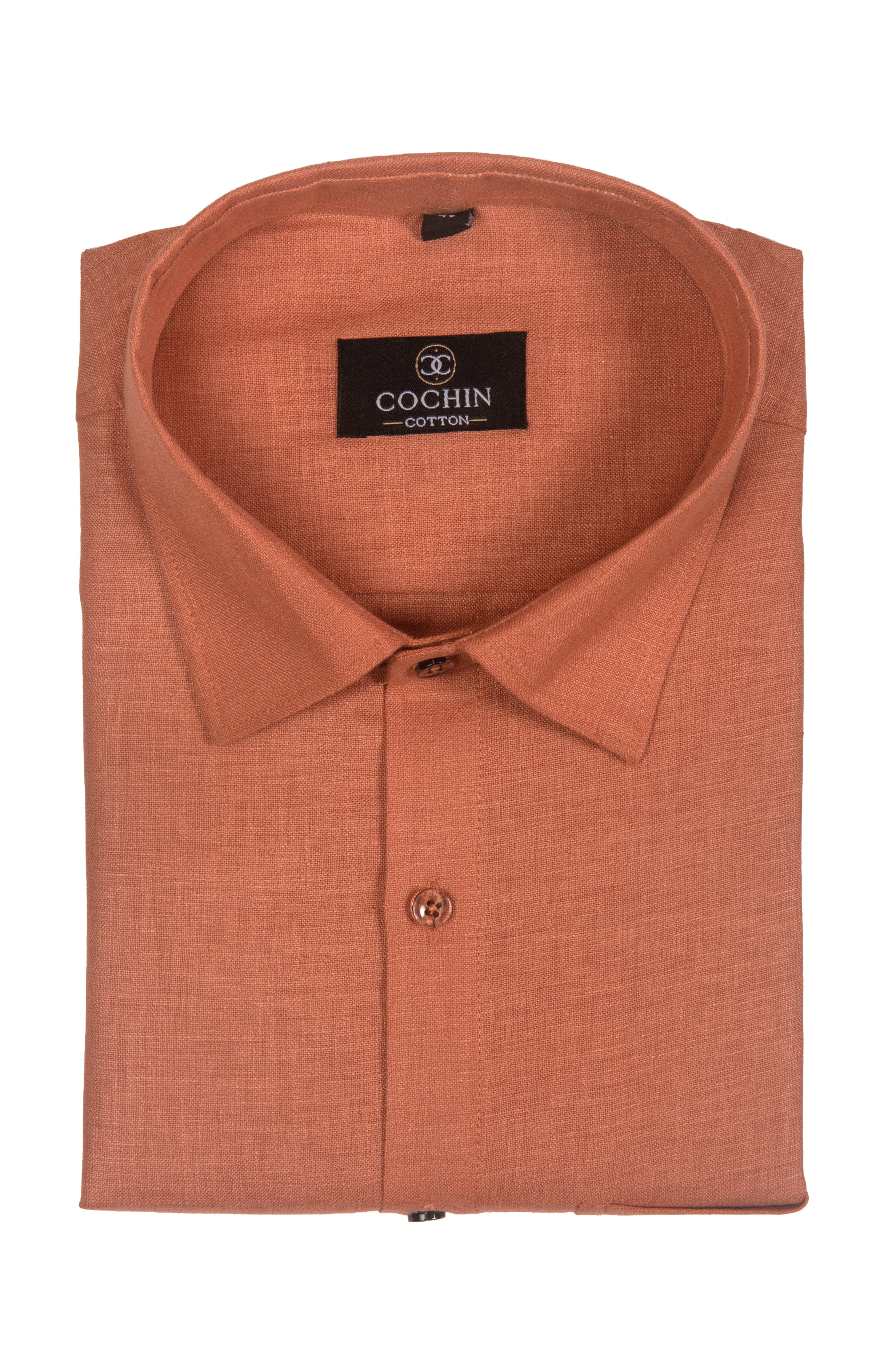 A folded long-sleeve button-up shirt in a textured terracotta orange fabric, featuring a black Cochin Cotton brand label on the inner collar.