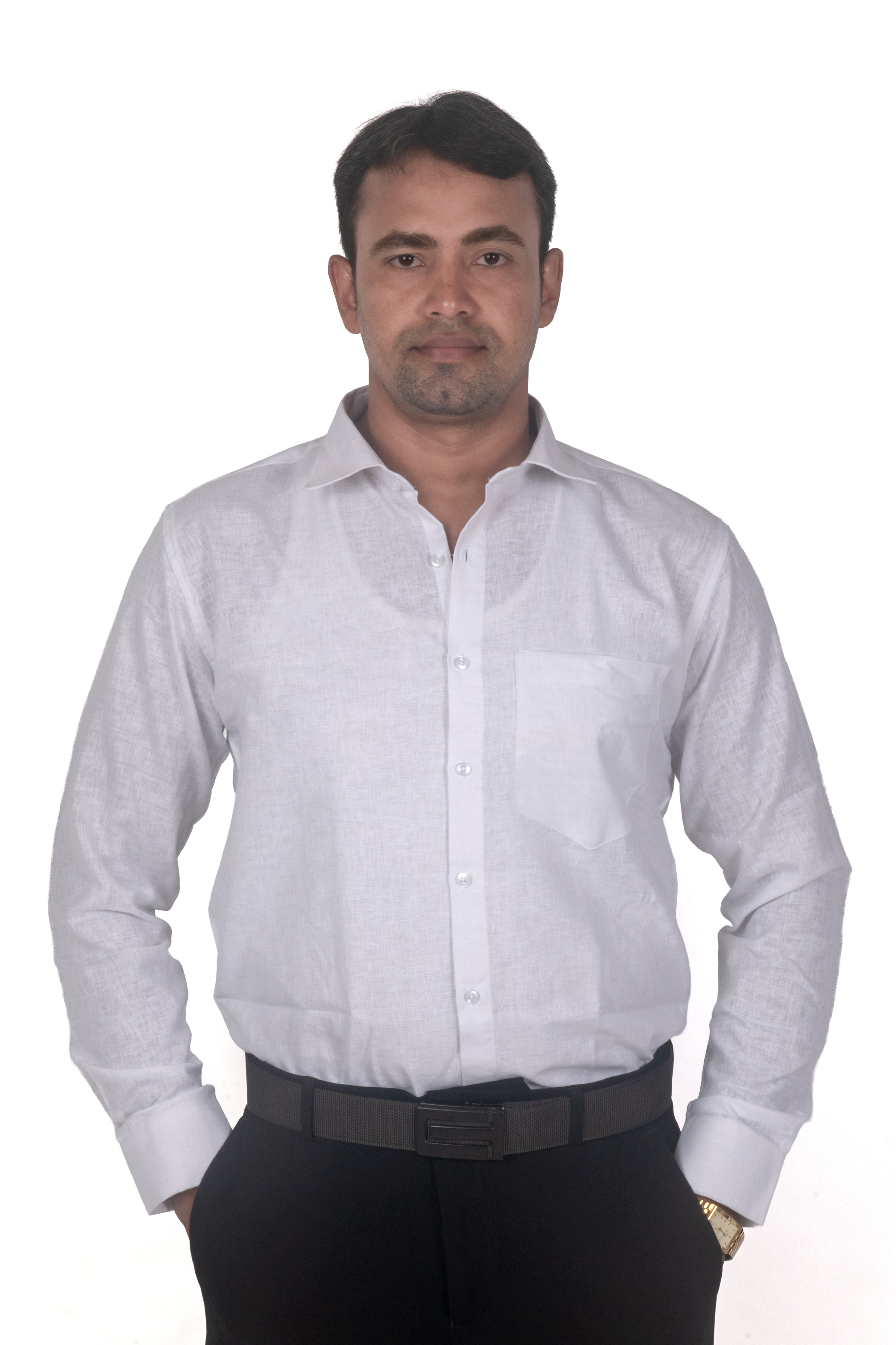 A man wearing a light gray long-sleeve linen button-down shirt, black trousers, and a black belt, standing against a plain white background.