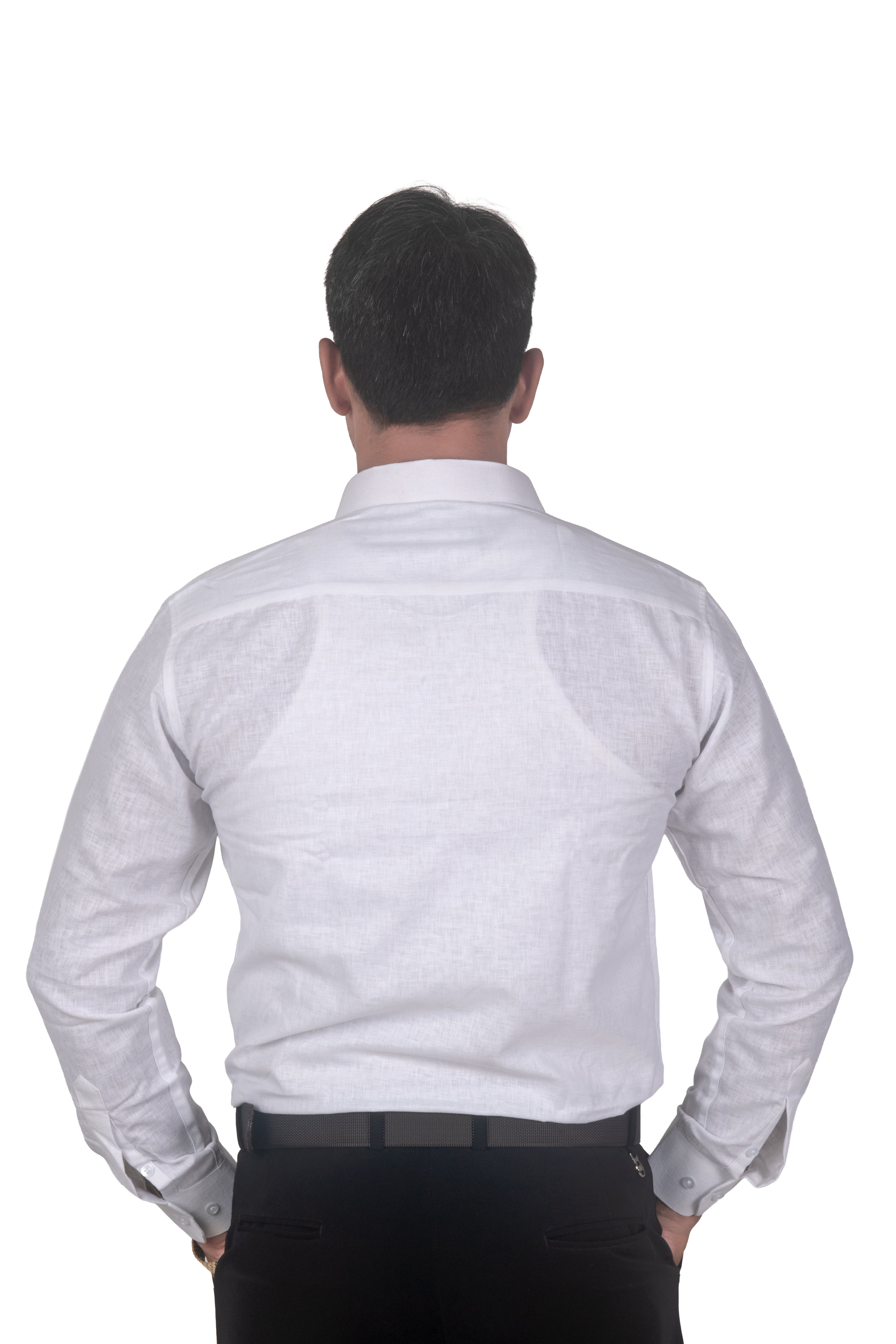 A man viewed from behind wearing a white long-sleeve linen shirt and black trousers, standing against a solid white background.
