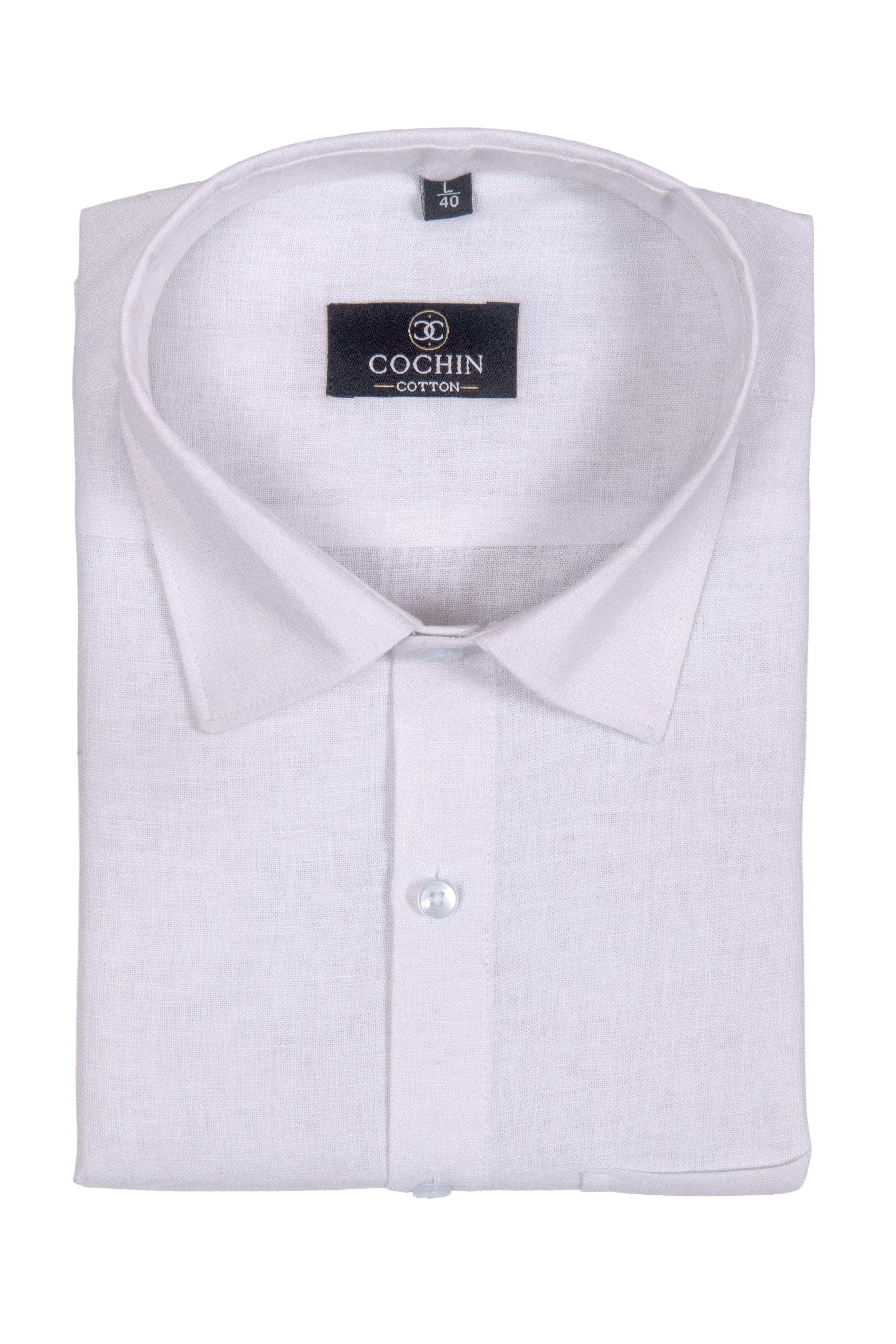 A folded white long-sleeve dress shirt with a pointed collar and a visible Cochin Cotton brand label inside the collar, shown on a plain white background.