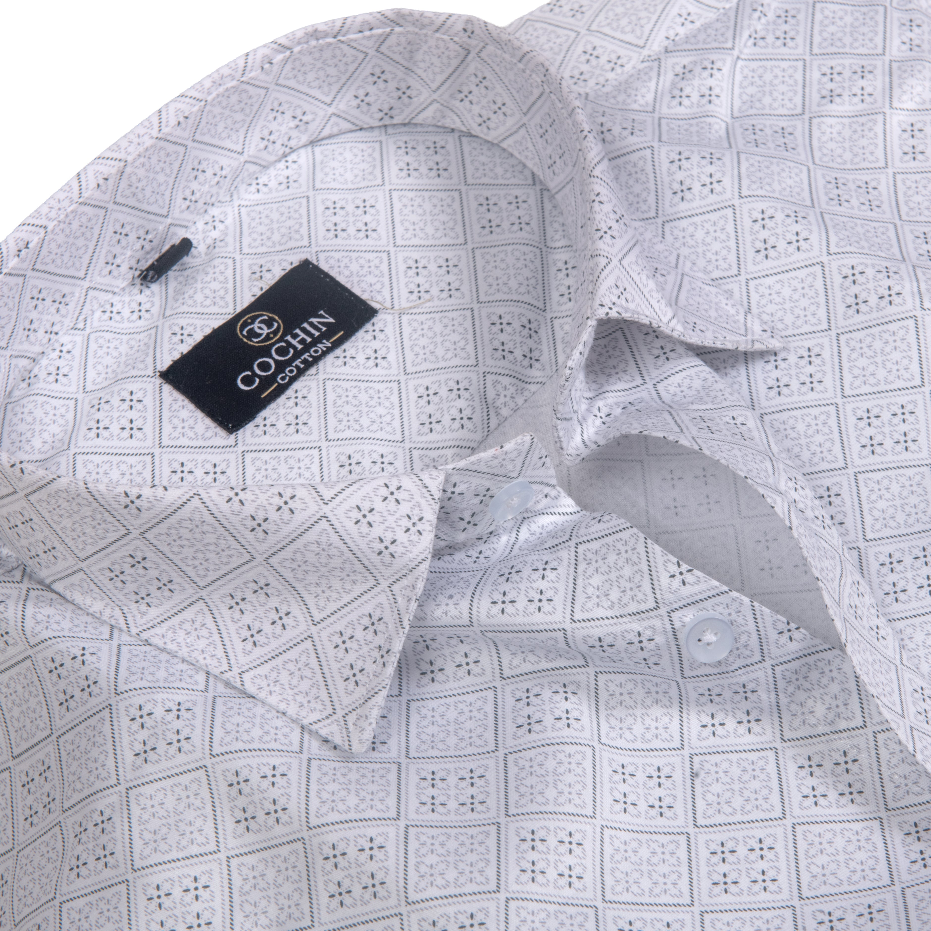 A close-up of a light gray and white patterned dress shirt by COCHIN CLOTHING, showing the collar, inner neck label, and repeating geometric print.